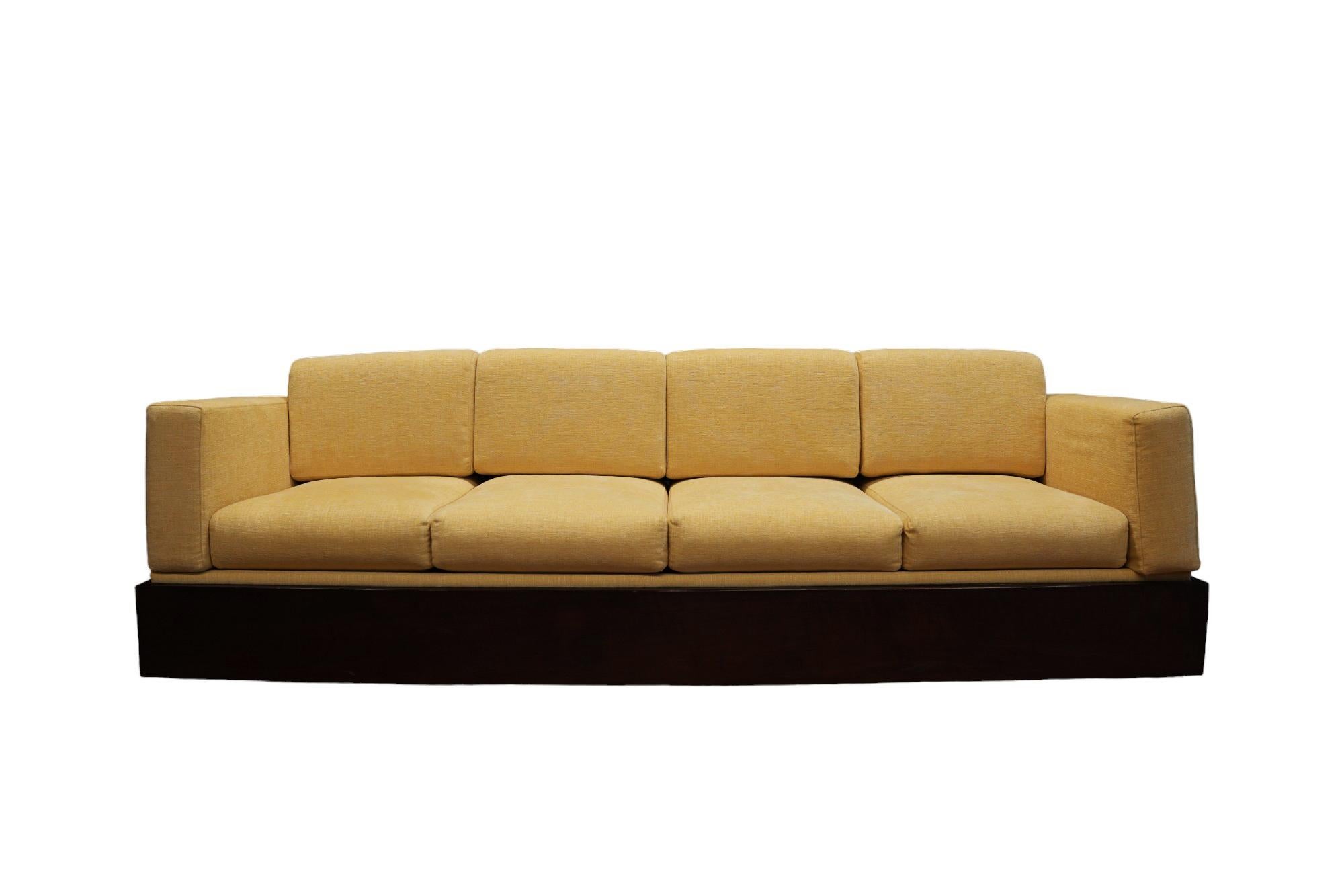 This Brazilian Modern Sofa in Hardwood and White Linen by Celina made in the 60s is nothing less than spectacular!

The frame of the sofa is made with Brazilian Rosewood  and the cushions have been reupholstered with Yellow Chenille. The shape of