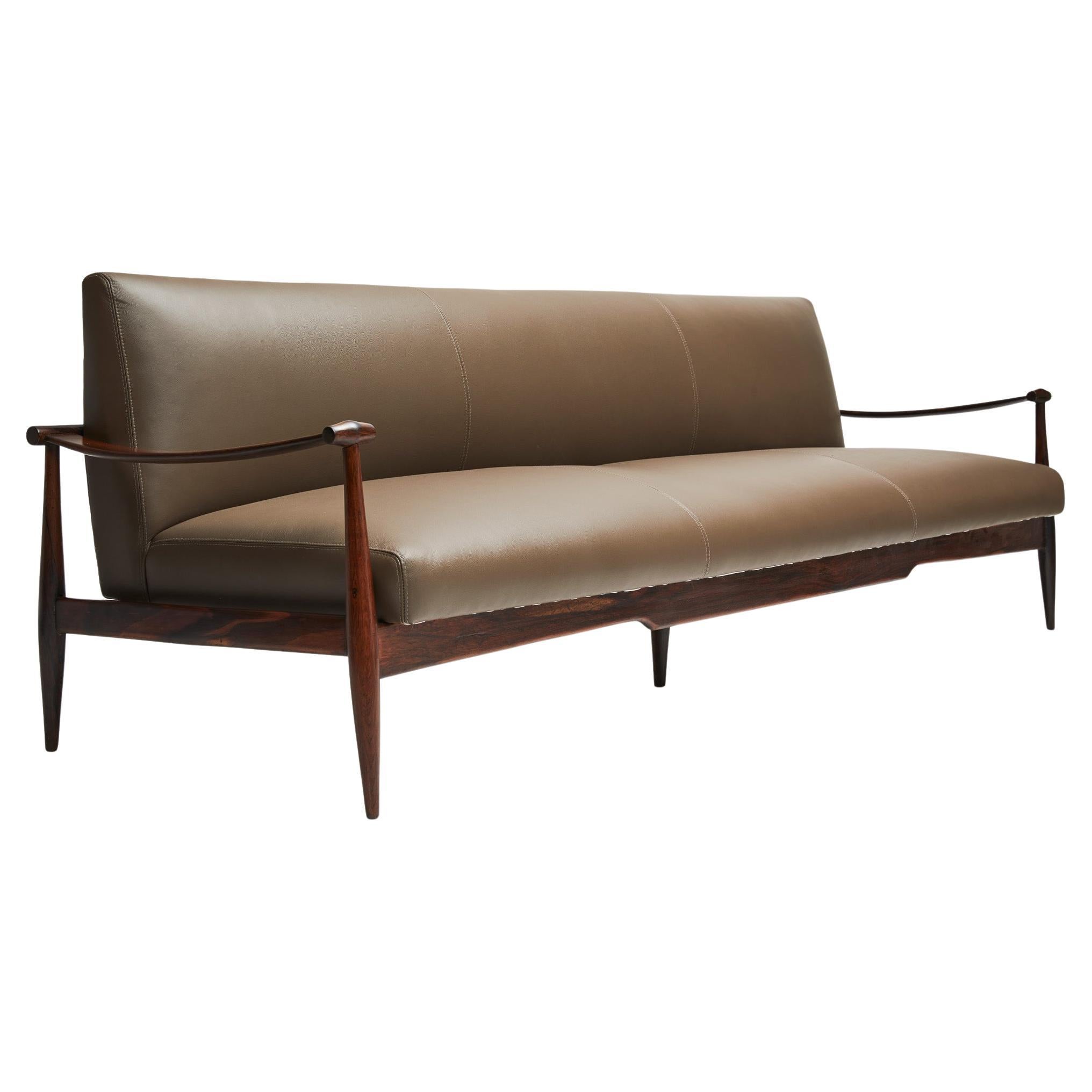 Available right now, with complimentary domestic shipping included this midcentury sofa in Brazilian Rosewood, as known as Jacaranda and brown leather designed by Liceu de Artes e Oficios is absolute stunning! 

The “Canoa” (canoe) model was