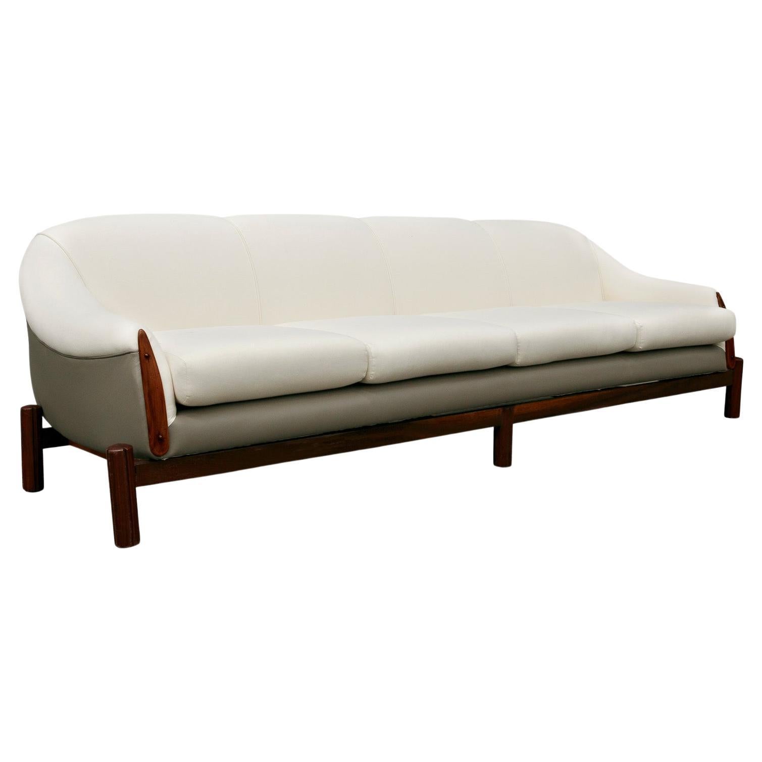 Available today, this Brazilian Modern sofa in hardwood, grey leather, and white fabric by Cimo, 1960s is simply fantastic!

This spectacular Sofa fits four very comfortably and features a Brazilian Rosewood (as known as Jacaranda) base with five