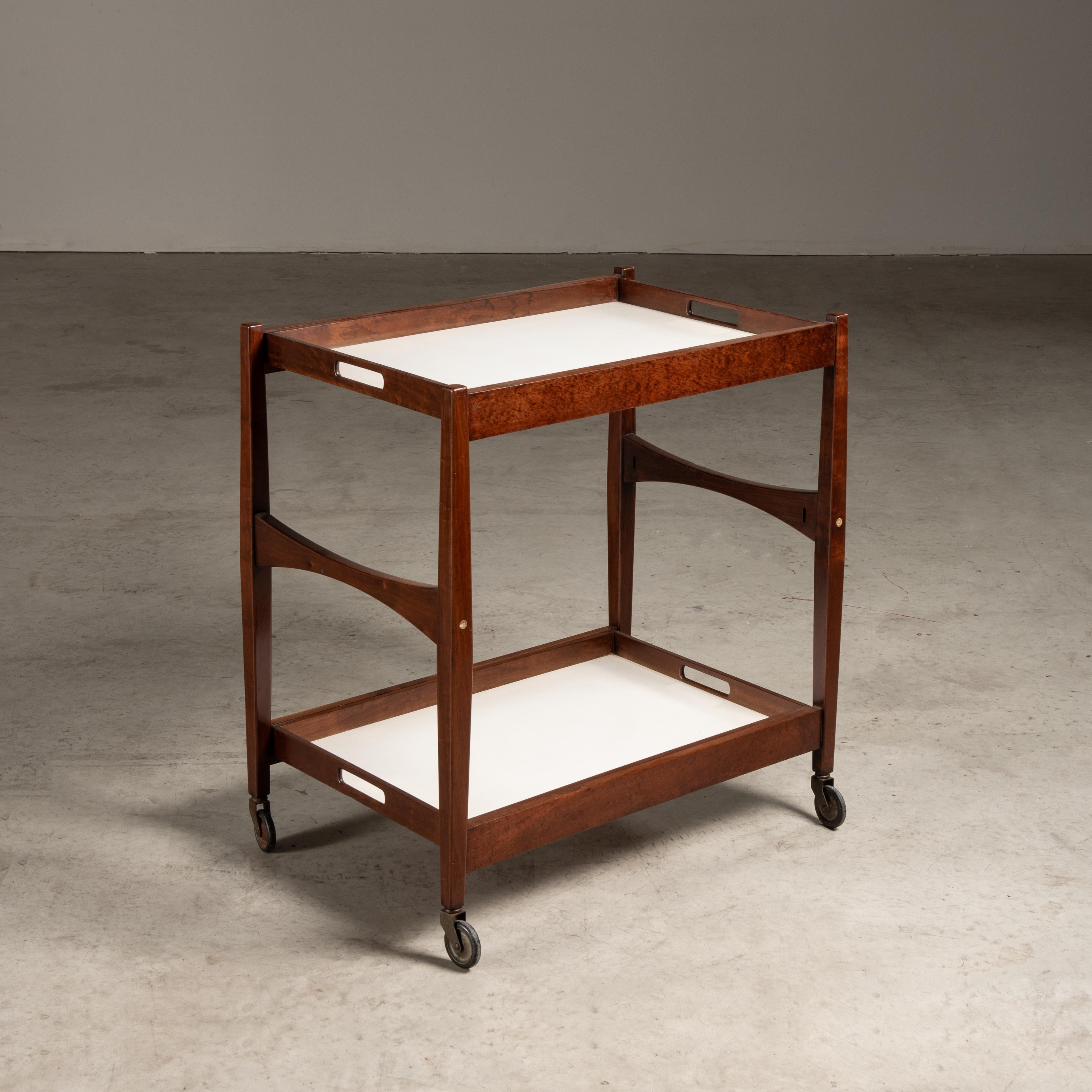This tea table cart, a product of mid-20th-century design, encapsulates the essence of the era with its functional form and use of both traditional and modern materials. The designer, though unknown, has left a distinctive mark through this piece,