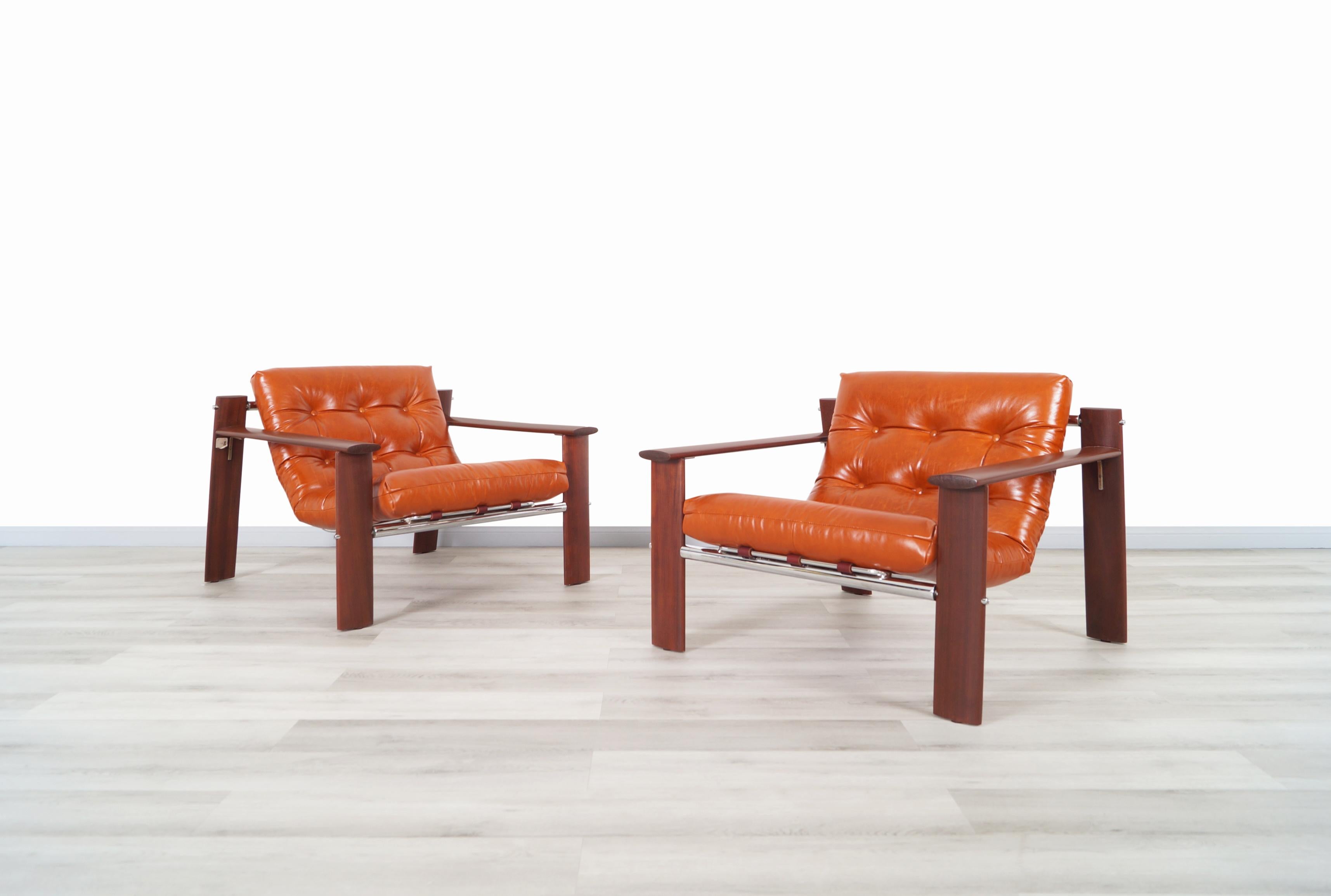 Visually stunning pair of rare vintage MP-129 lounge chairs designed by architect and furniture designer Percival Lafer from Brazil. These phenomenal chairs are simply amazing! Features a sculptural and exotic Jacaranda wood frame native from