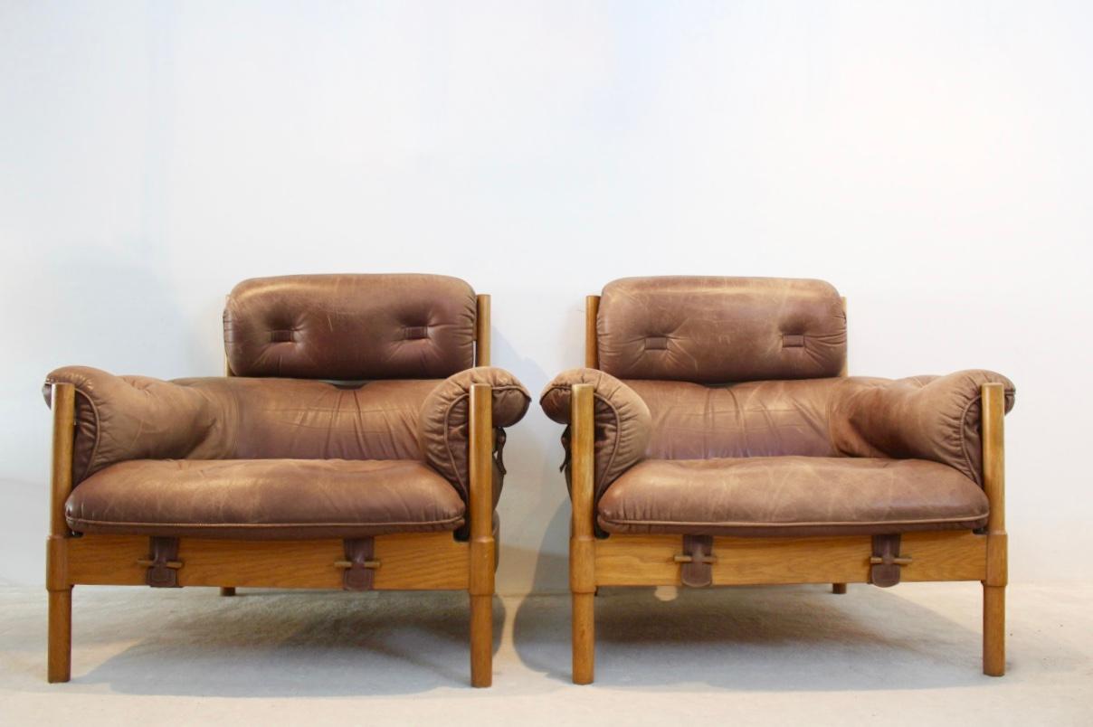 A wonderful original matching 1970s Brazilian Set of two lounge chairs attributed to Percival Lafer. This amazing set of two 1-seat have a solid oak frame and soft Brazilian brown cognac leather cushions with beautiful patina. The frame is finished