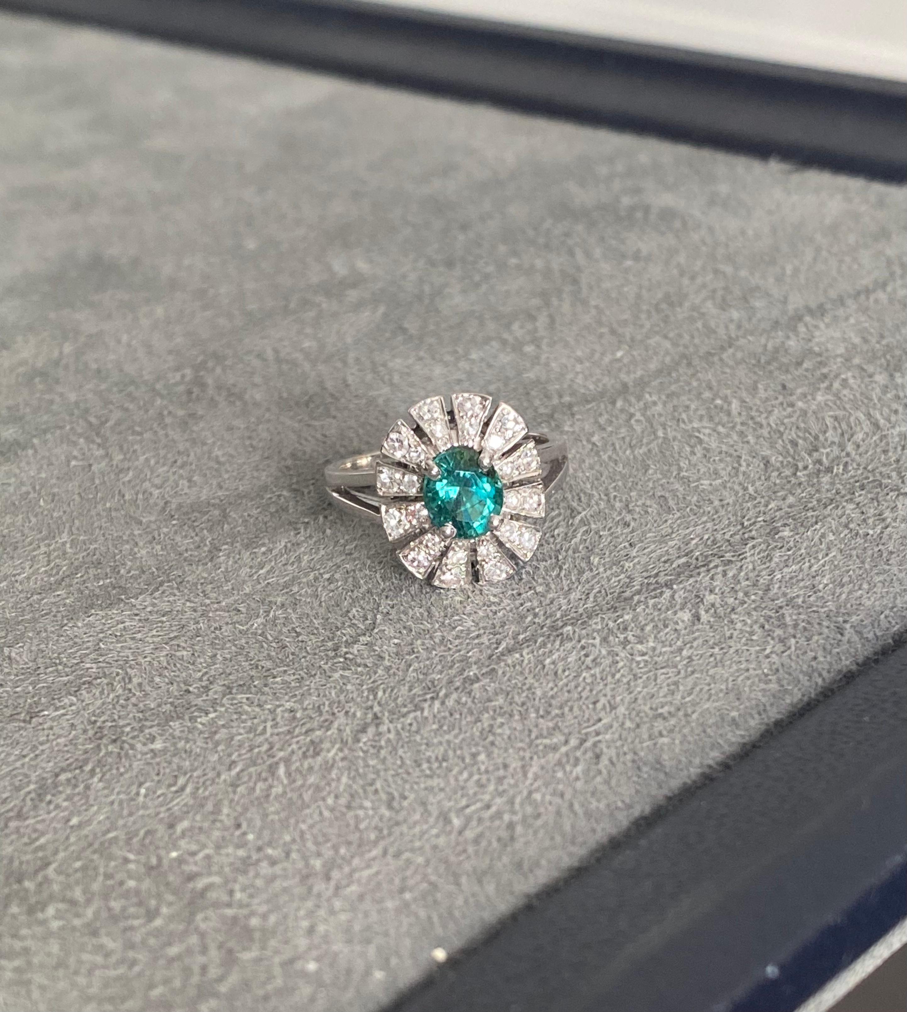 A GRS certified Brazilian Paraiba Tourmaline of 1.14ct set with single cut diamonds (approx 1ct total) in 18k White Gold. Size 54. 