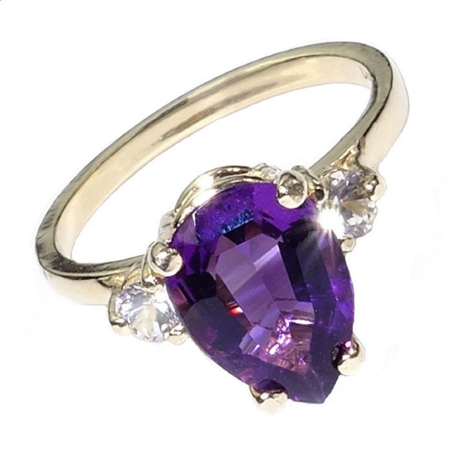 Gorgeous, sparkling Brazilian Amethyst set in 14k Yellow gold ring.  This bright pear shaped Amethyst is enhanced by two White Sapphires.  The Amethyst is 1.86ct and the two White Sapphires are each 3mm.  Amethyst is the February birthstone.  Size 7