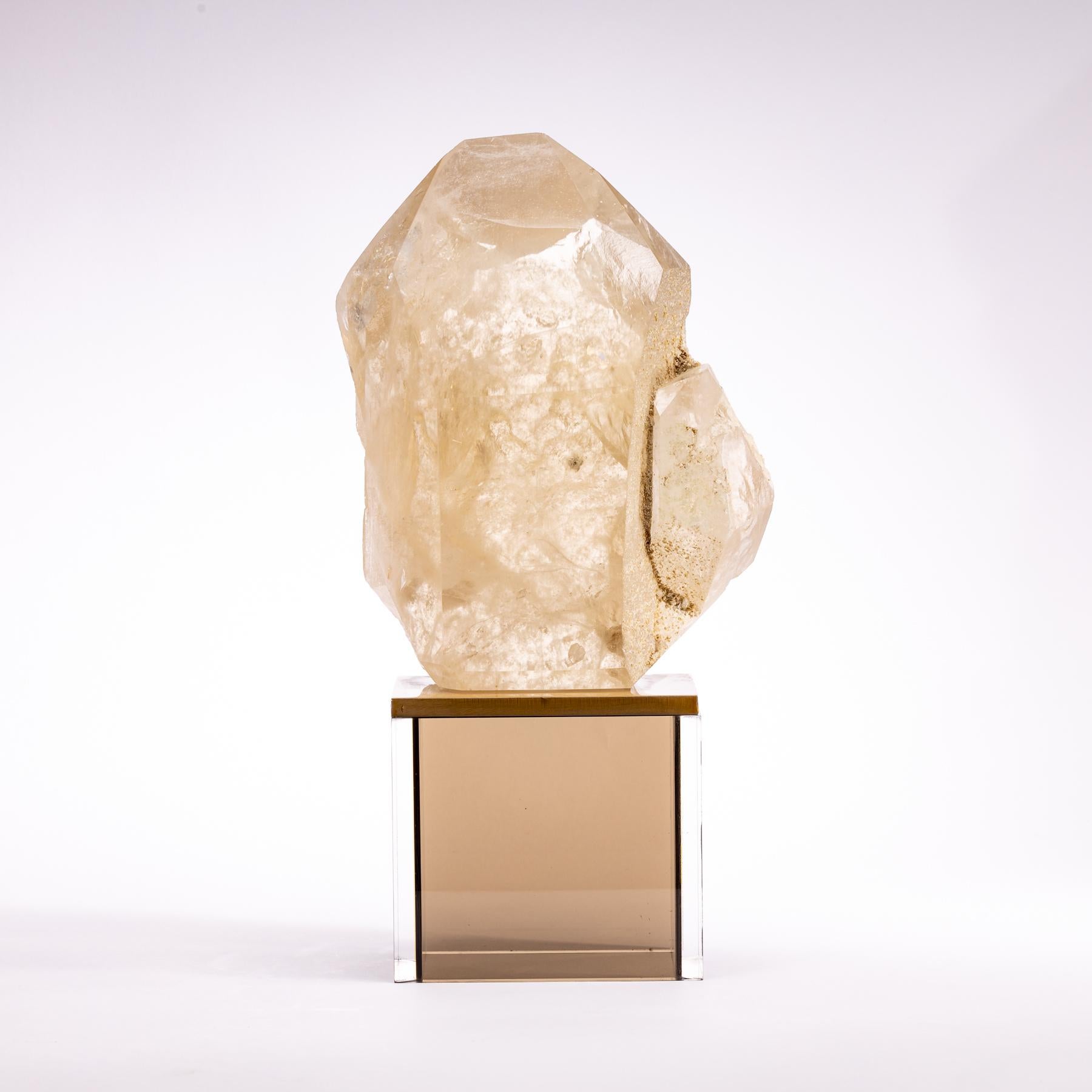 Natural large quartz point from Brazil mounted on a custom metal and smoky acrylic stand.