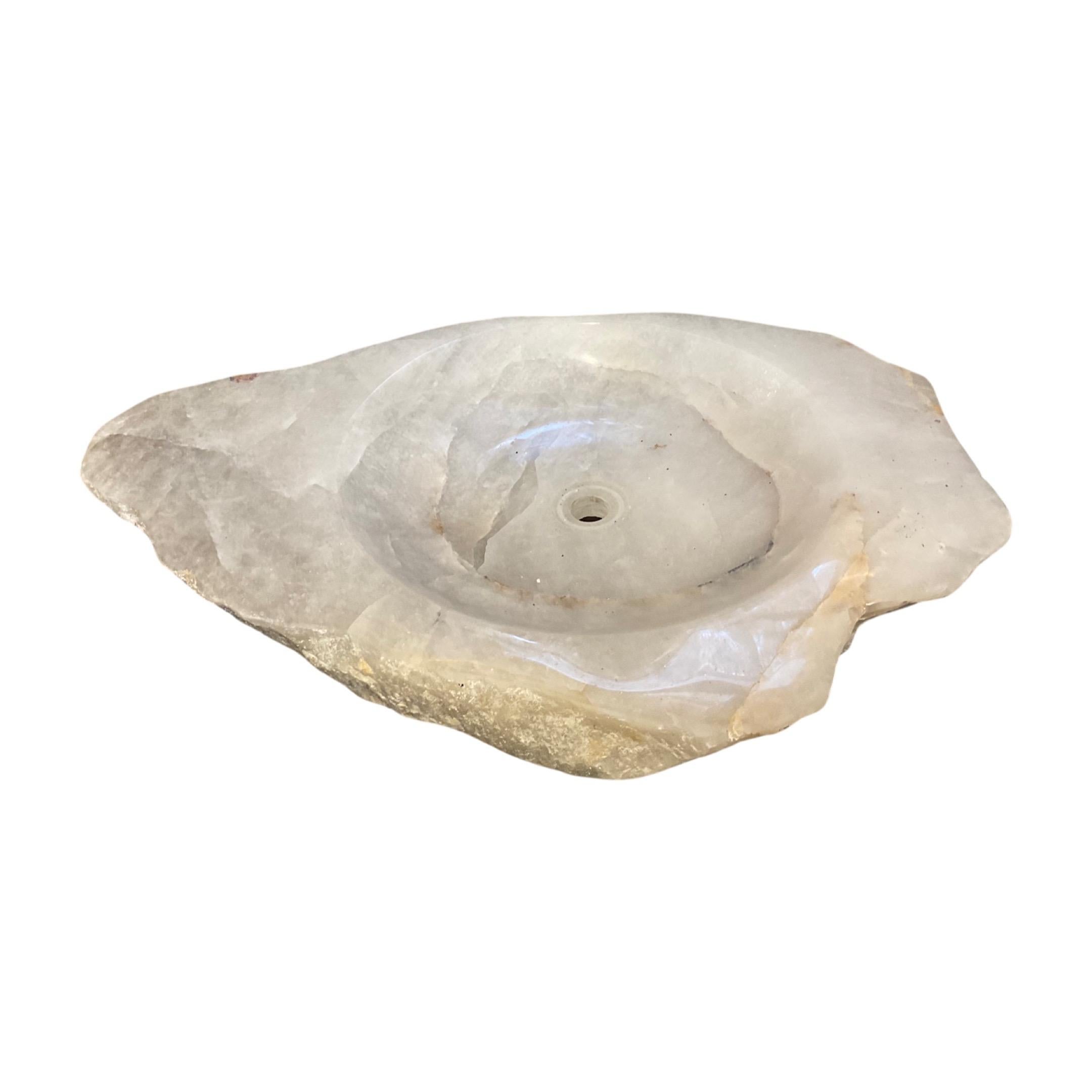 This Brazilian rock crystal sink bowl is crafted from natural quartz, providing a stunning, modern look. Its smooth, glossy surface is durable and easy to clean, making this an ideal choice for any bathroom or kitchen. This natural quartz sink bowl