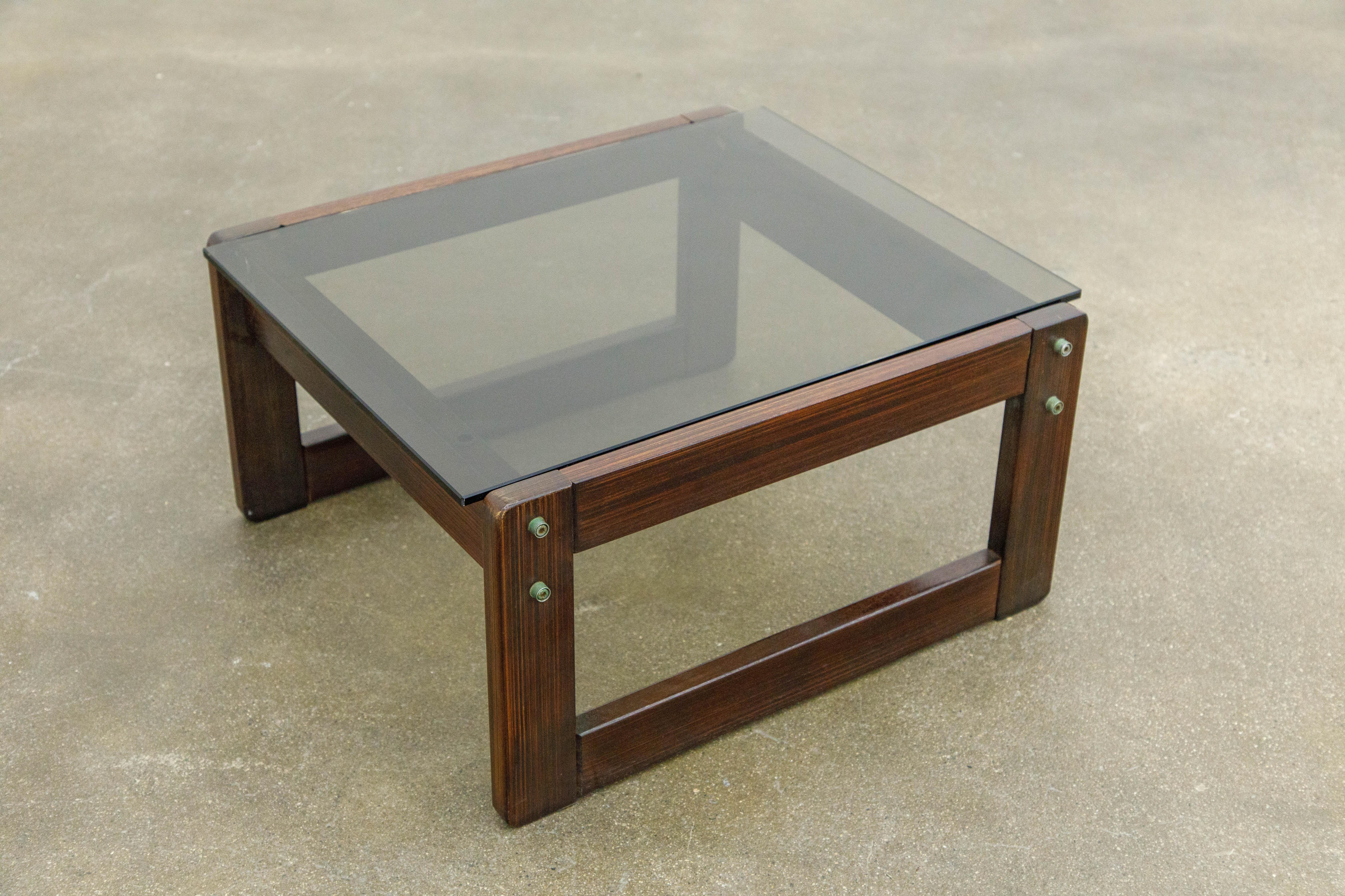 A beautiful Brazilian Rosewood and smoked glass side table by coveted designer Percival Lafer. This 1960s end table was made in Brazil and is signed with Lafer sticker label as seen in the photos. As rosewood is now an endangered species and