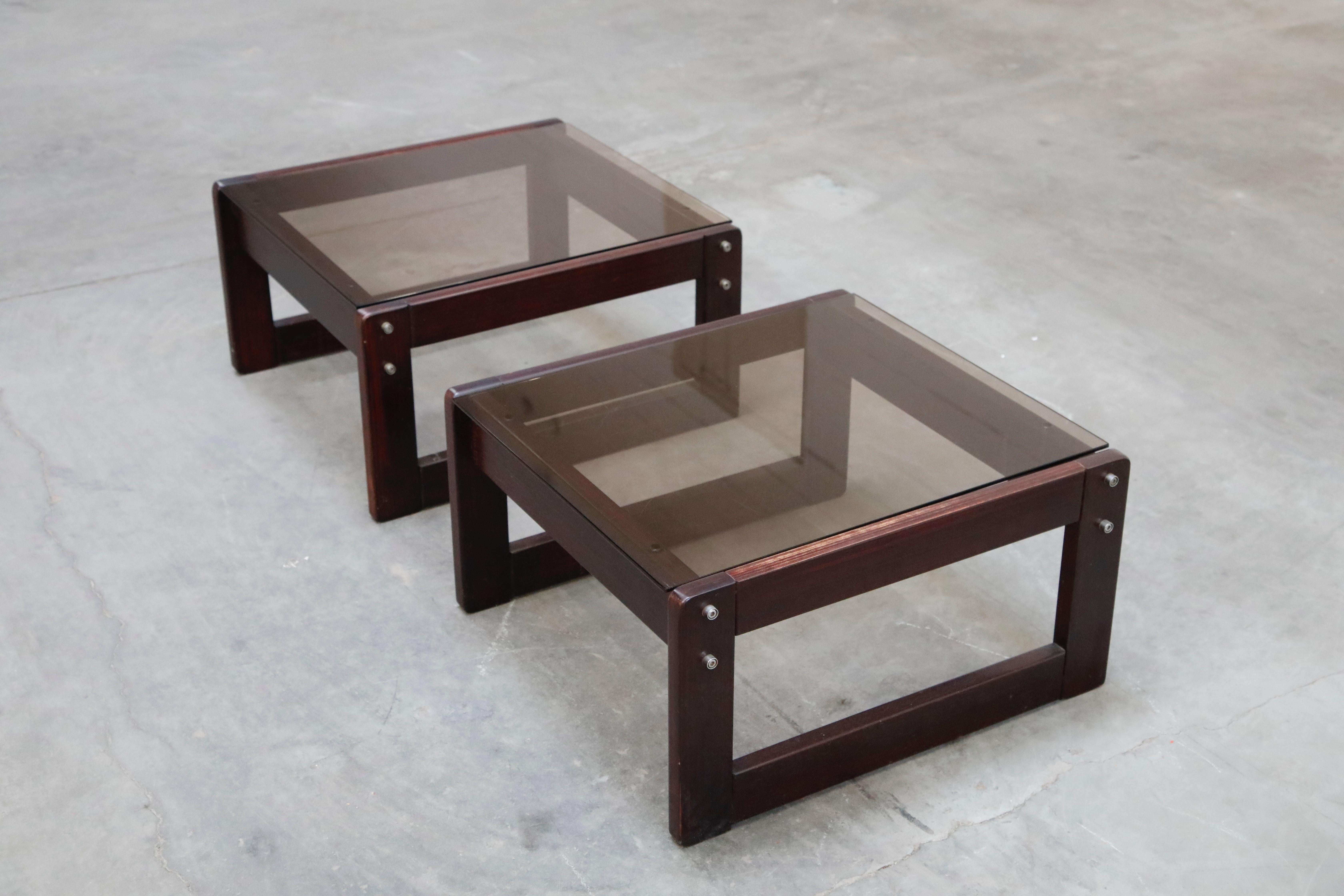A fantastic pair of beautiful Brazilian rosewood and smoked glass side tables by coveted designer Percival Lafer. These 1960s end tables were made in Brazil and are a favorite amongst collectors, designers, artists and galleries. As rosewood is now