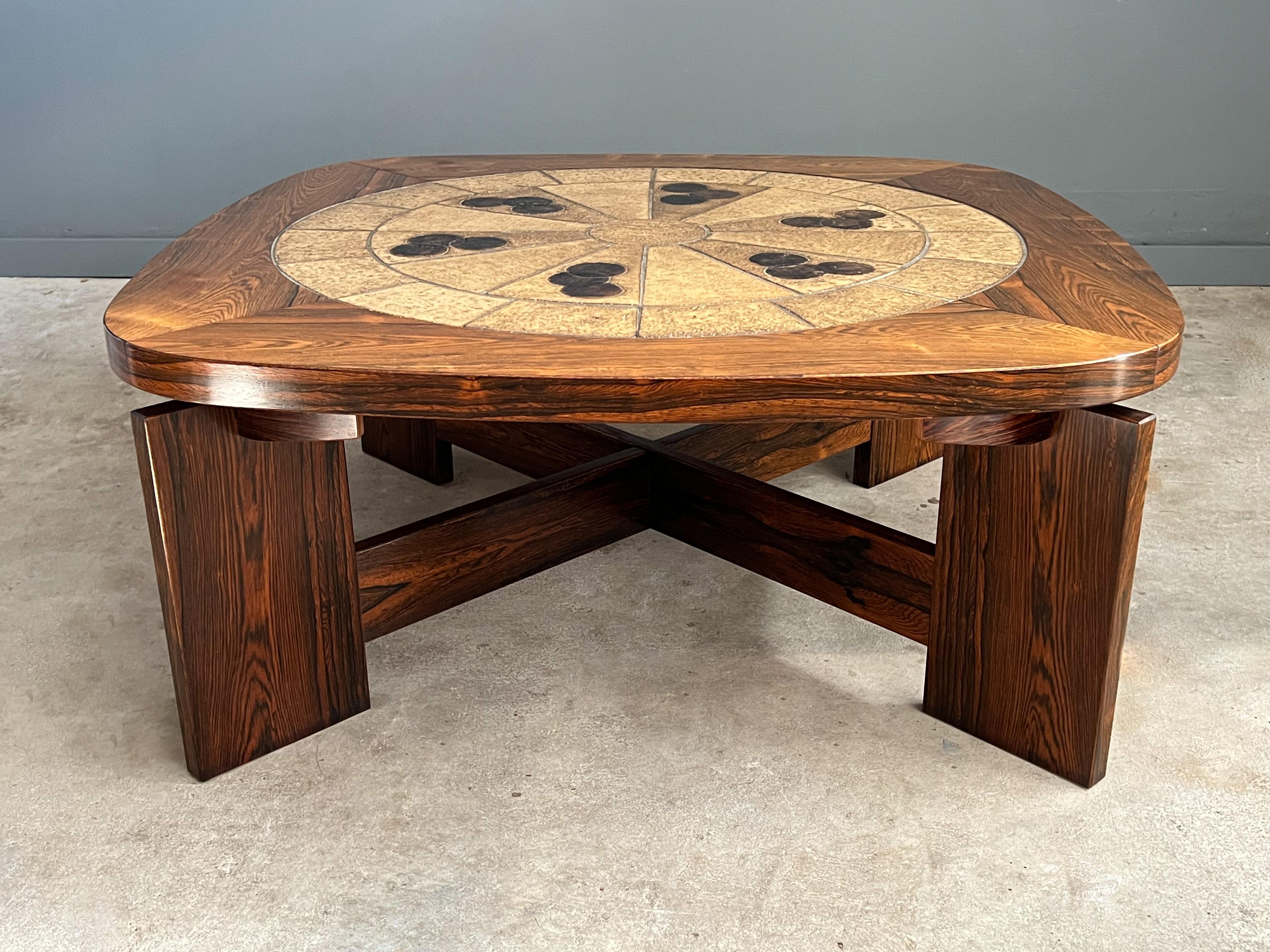Brazilian rosewood and tile coffee attributed to Tue Poulsen, Denmark 1970s. This amazing example shows off an abstract ceramic pattern in warm neutral colors and is complemented by the Brazilian rosewood grain. The base is architectural in form,