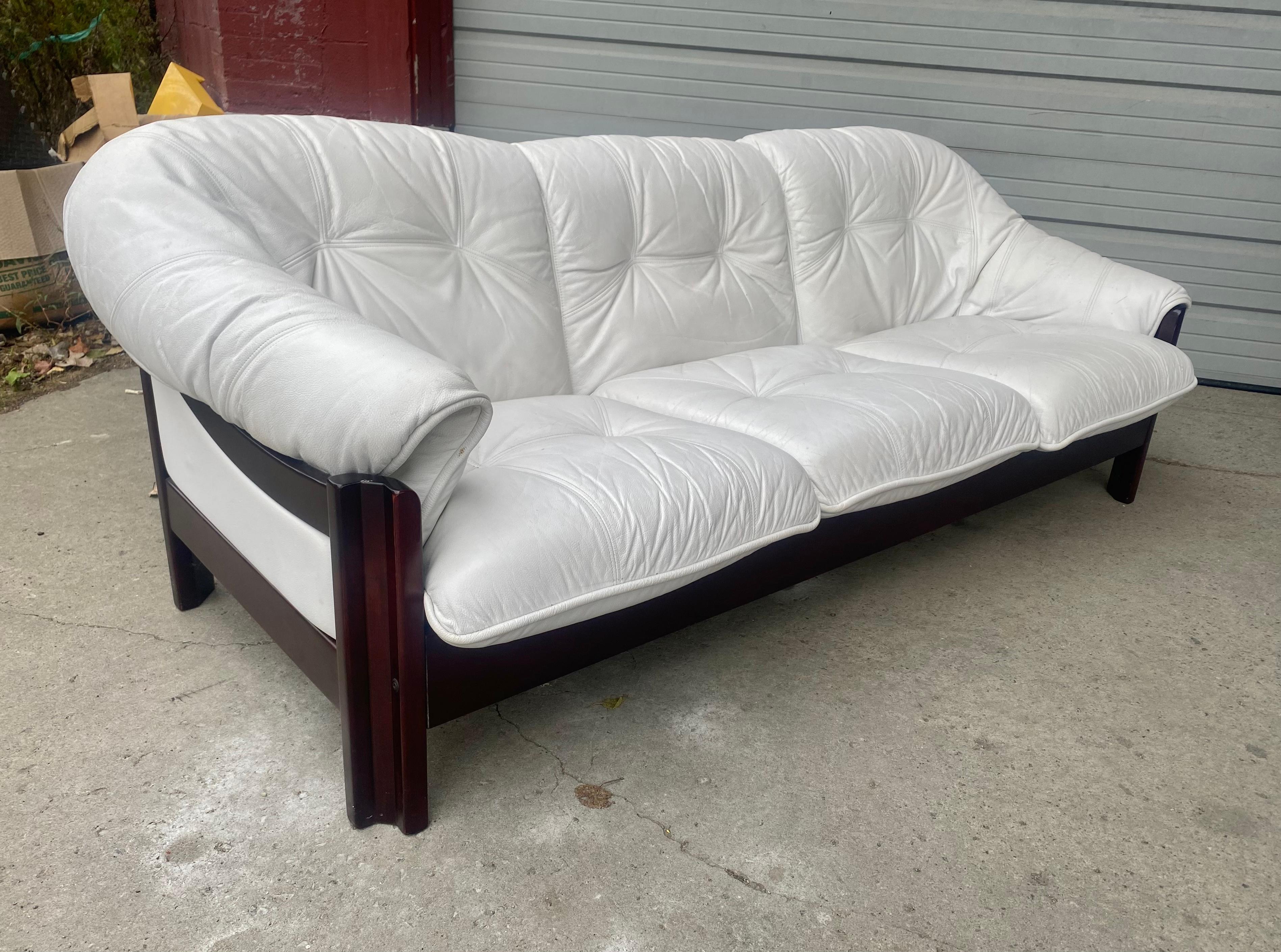BraziLIAN  Rosewood and  White Leather Sofa by Jean Gillon for Probel S.A... Classic Modernist 1970's design.. Extremely comfortable.. Superior quality and construction.Retains its original ,super quality , white leather upholstery.. minor scratches