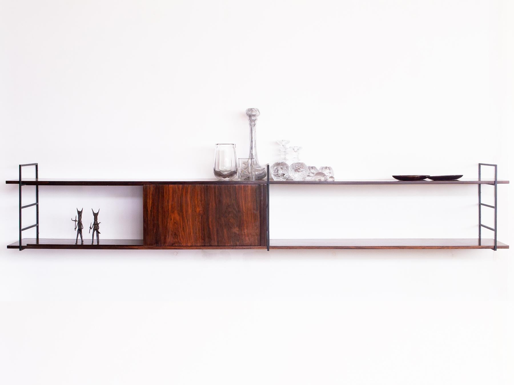 Amazing wide console with sliding door, produced in rosewood veneer and wrought iron. This beautiful minimalist piece floats on your desired height and looks great against light walls, making the rosewood tones stand out even more.