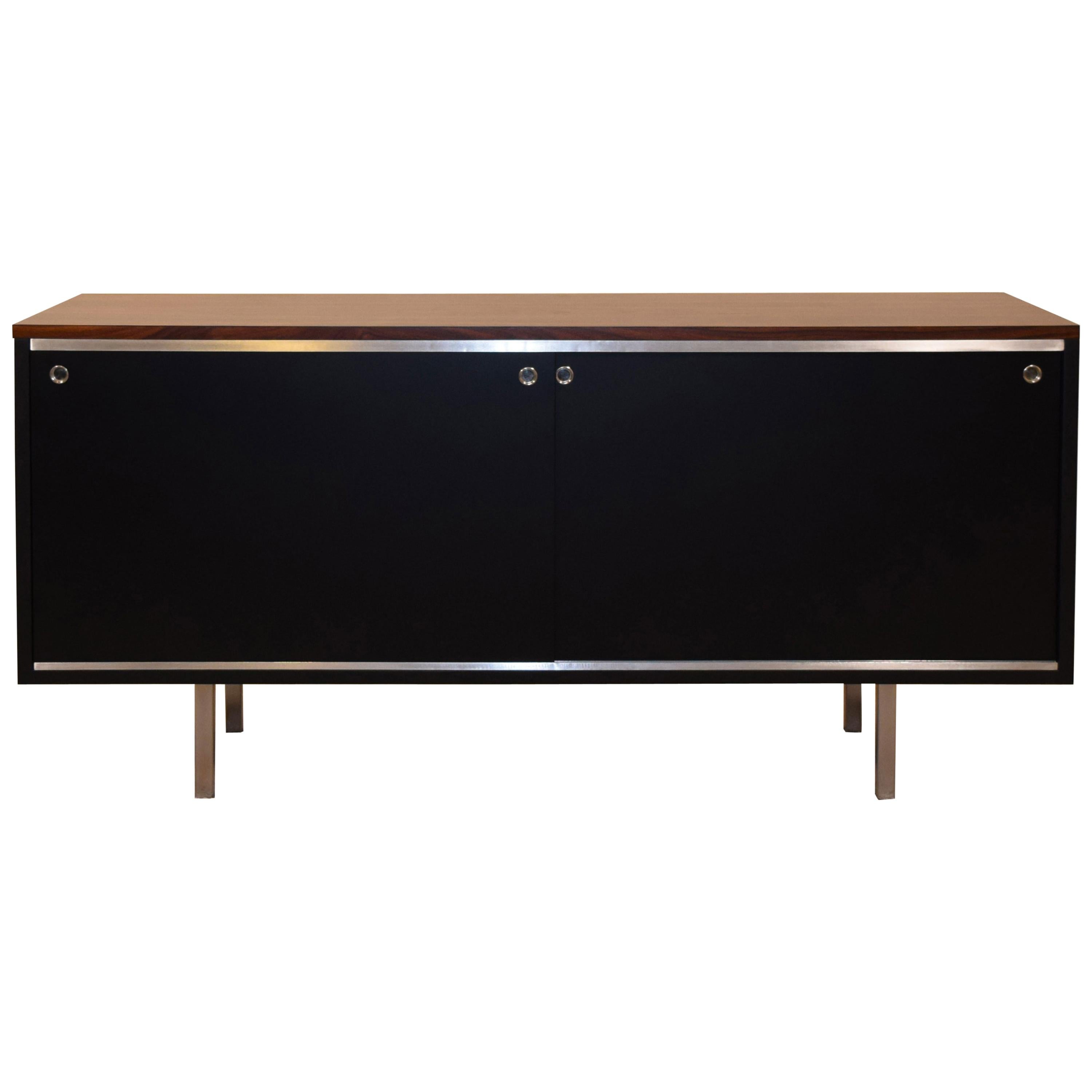 Early credenza with black shell and rosewood top, circa 1952. Measures 55.5