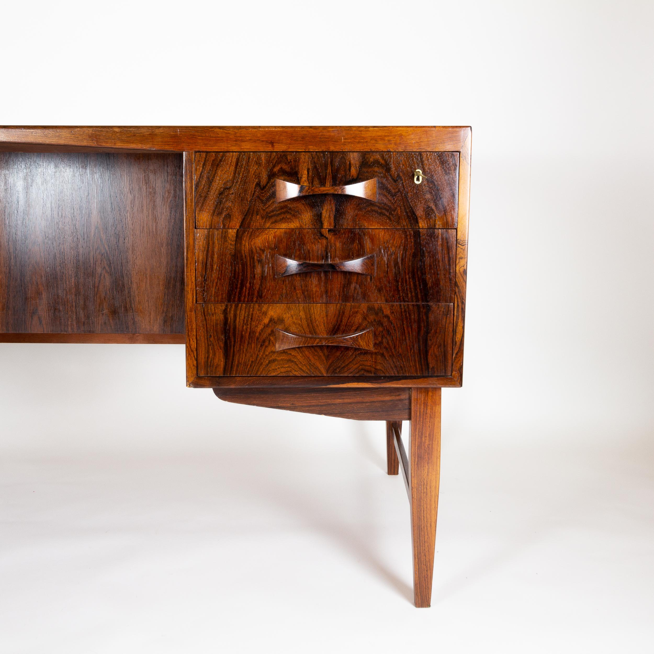 A fabulous Brazilian rosewood desk, Denmark, 1960s. Top drawers are locking. Double sided with bookshelf to the rear.