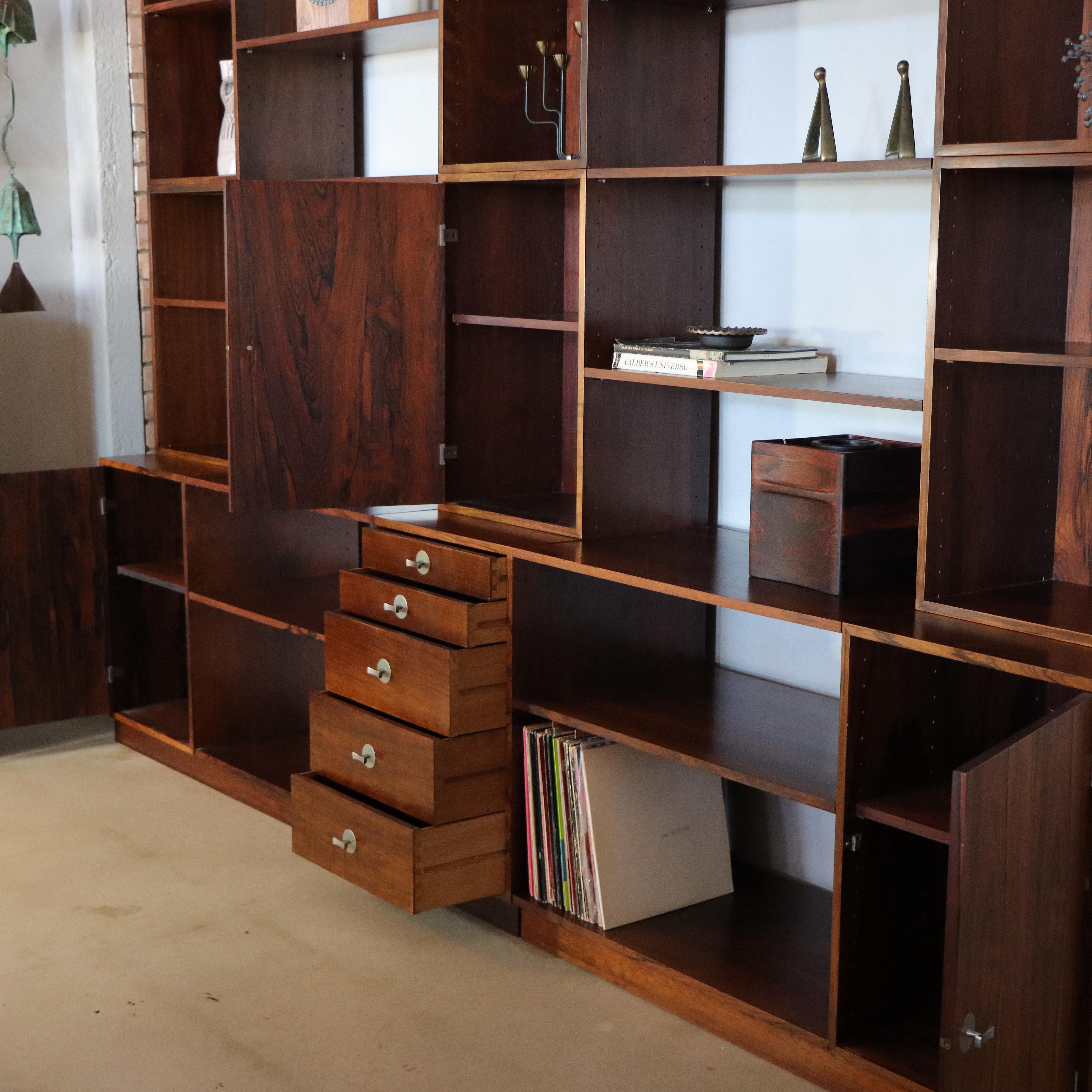 Modular wall system designed by Finn Juhl for France & Son, c. 1966. Normally seen in teak, this Brazilian Rosewood example is stunning beautiful. 

This unit consists of three closed cabinets, one chest of drawers, and multiple shelves. Each box