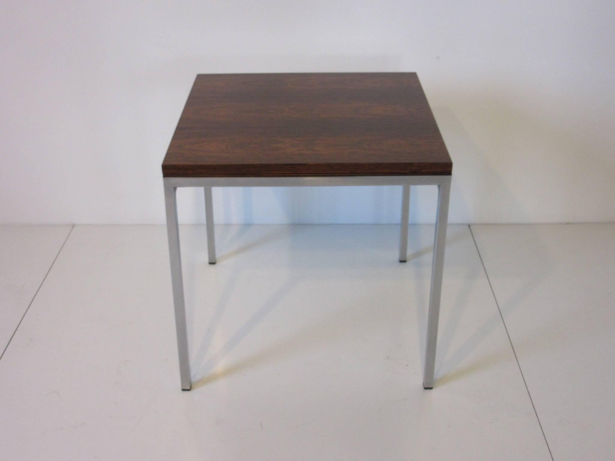A dark and wonderfully grained Brazilian rosewood side table with satin chromed frame, when slid and flipped it turns into a coffee table. A great piece for that special place, retains the manufactures tag to the bottom WR. When closed it measures