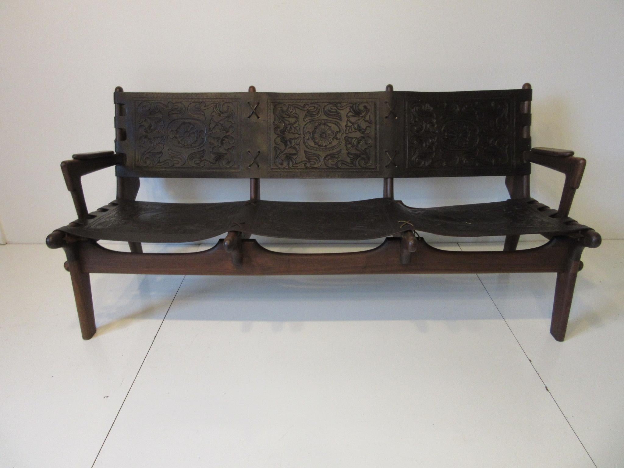 A handcrafted three-seat sofa by famed designer and craftsman Ecuadoran Angel Pazmino made during the height of the 1960s Mid-Century Modern movement in South America. Made of solid rosewood using pegs and fitting together like a interlocking