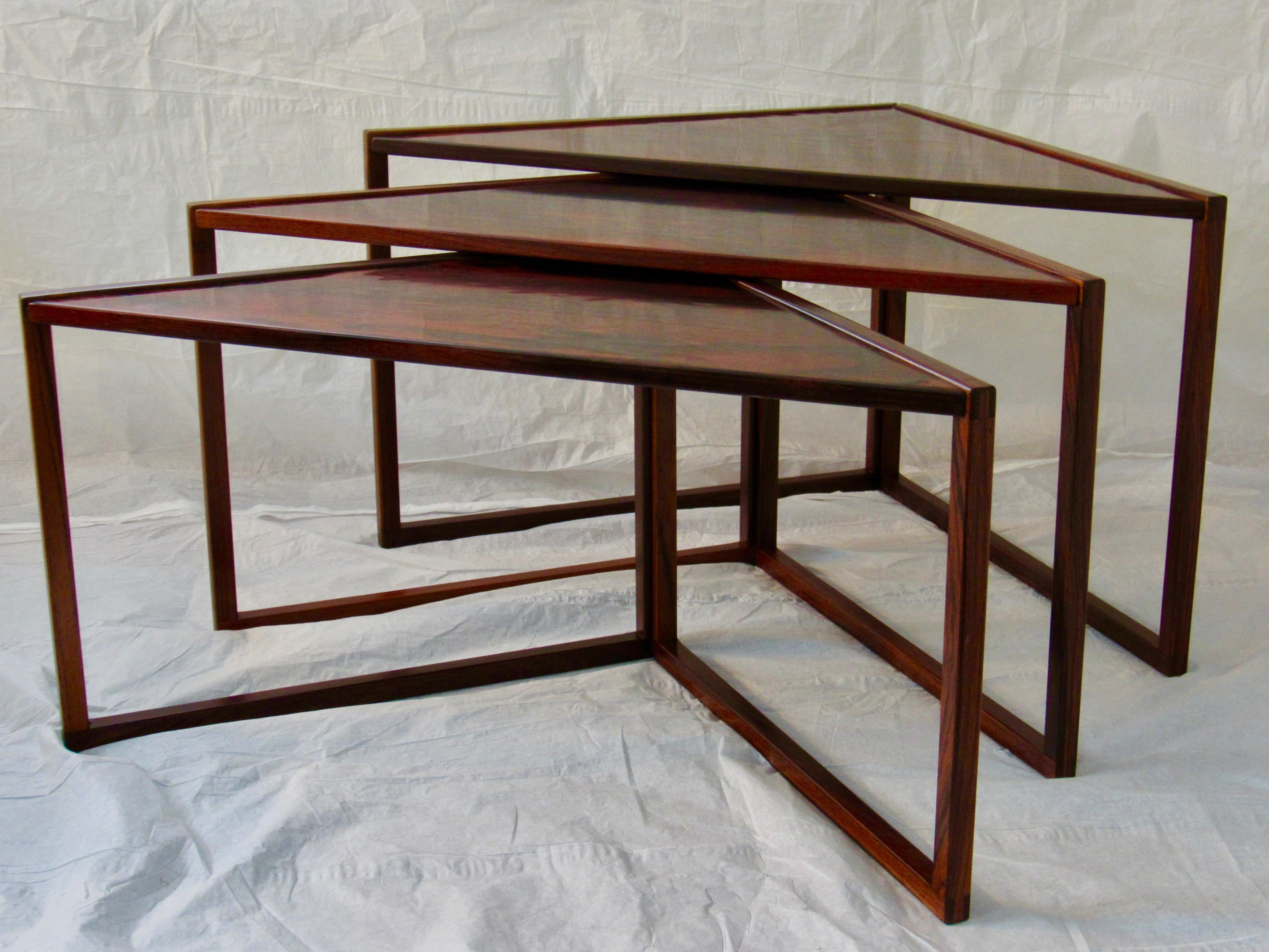 Kai Kristiansen for Vildbjerg Mobelfabrik design rare set of 3 rosewood nesting tables produced in Denmark, 1960. 
The beautifully grained Brazilian rosewood veneer sets within solid rosewood frames. 
This nesting table by Kai Kristiansen is listed