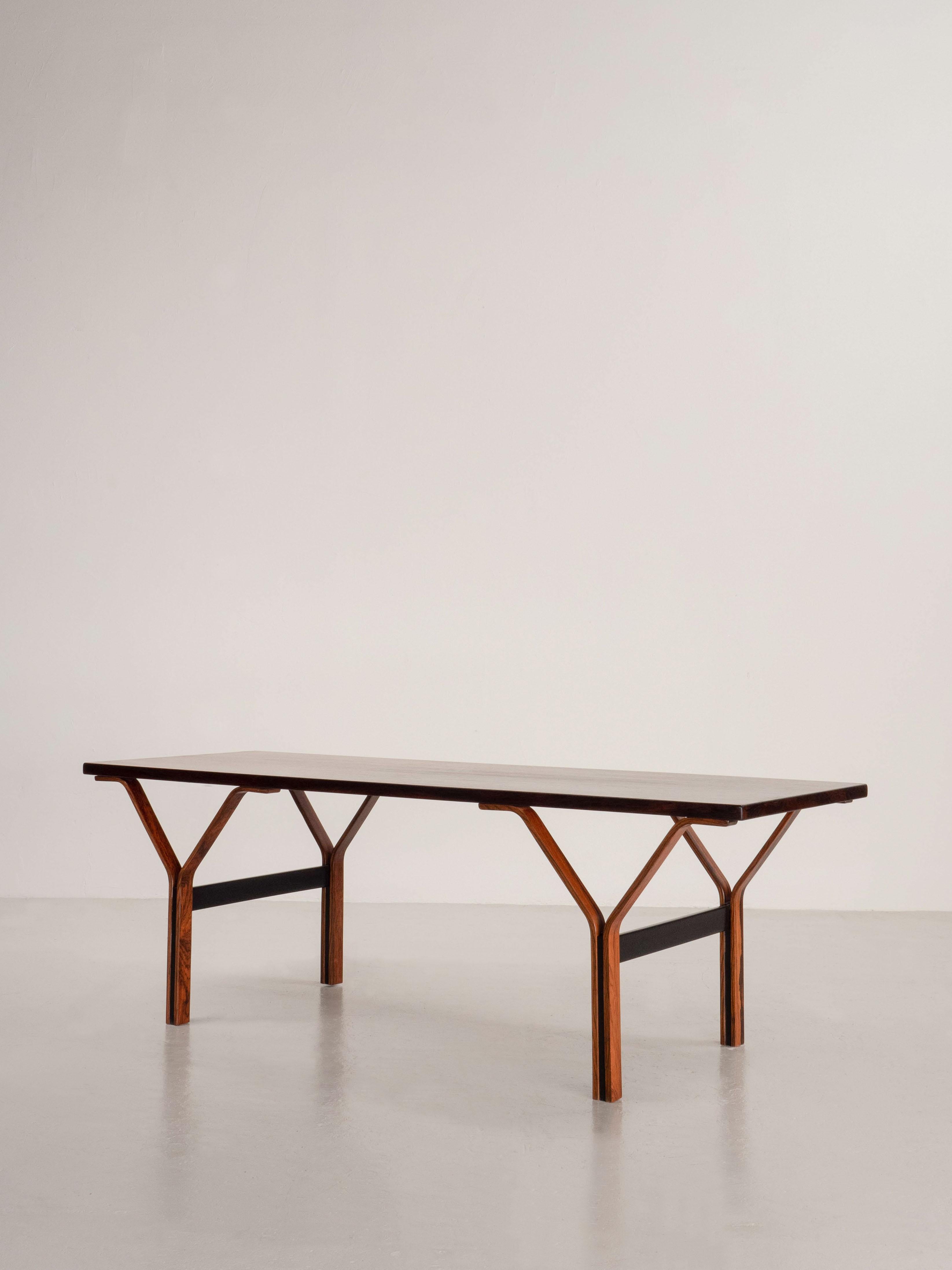 Rectangular coffee table made from Brazilian rosewood. The piece was made in Denmark most likely in the 1960's/1970's. Sculpted legs and a striking grain.

The table has been refinished and is in excellent condition with light wear. Hand signed