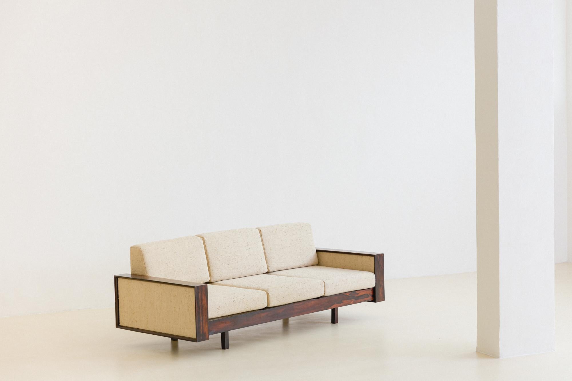 This sofa was produced by the Brazilian company Celina Decorações in the 1960s. The sofa is made of solid Rosewood, with seats and backs upholstered with a gorgeous fabric 100% Organic Silk, from our collection Bossa Fabrics. 

The armrests have a