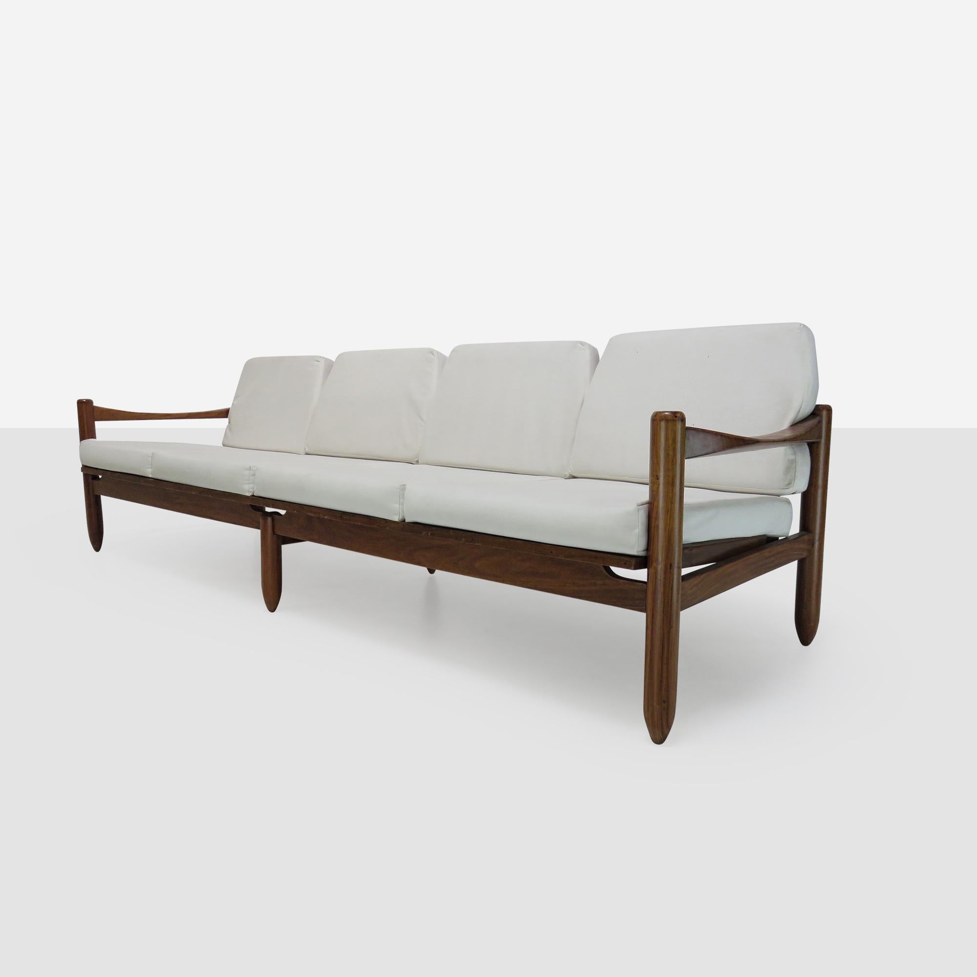 A Brazilian hardwood sofa. Attractive slatted back, cyclindrical legs and curved arms. Cushions not included.

We have matching side chairs, coffee and side table.