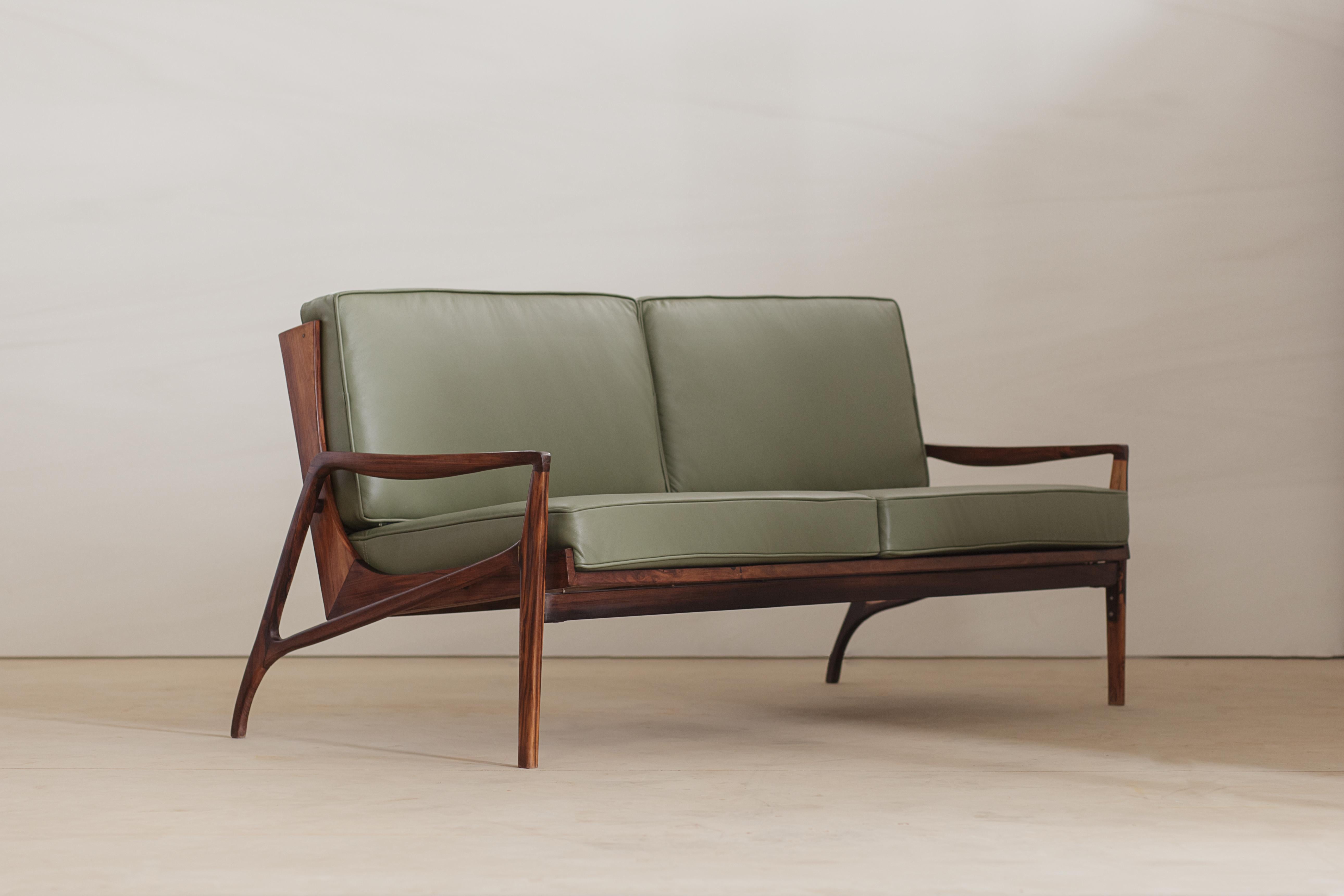 Two-seat sofa designed by Liceu de Artes e Oficios in solid rosewood, Sao Paulo, Brazil, 1960s. The piece has been recently refinished and newly upholstered in natural leather. 

Liceu De Artes & Oficios was established in 1873 by a group of elite