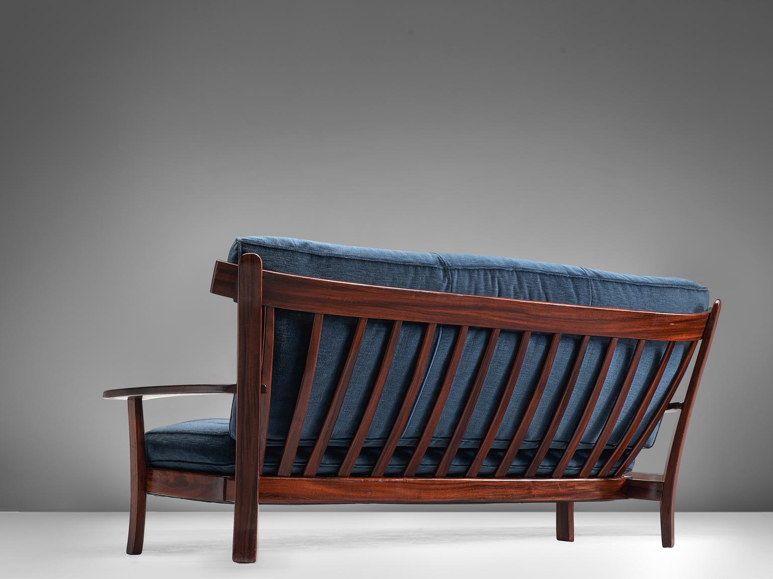 Sofa, rosewood, velvet, Brazilian design, European execution, 1960s.

This settee is executed in Brazilian rosewood and velvet and holds several well-constructed details such as the slatted back and the use of slender and delicate slats of rosewood