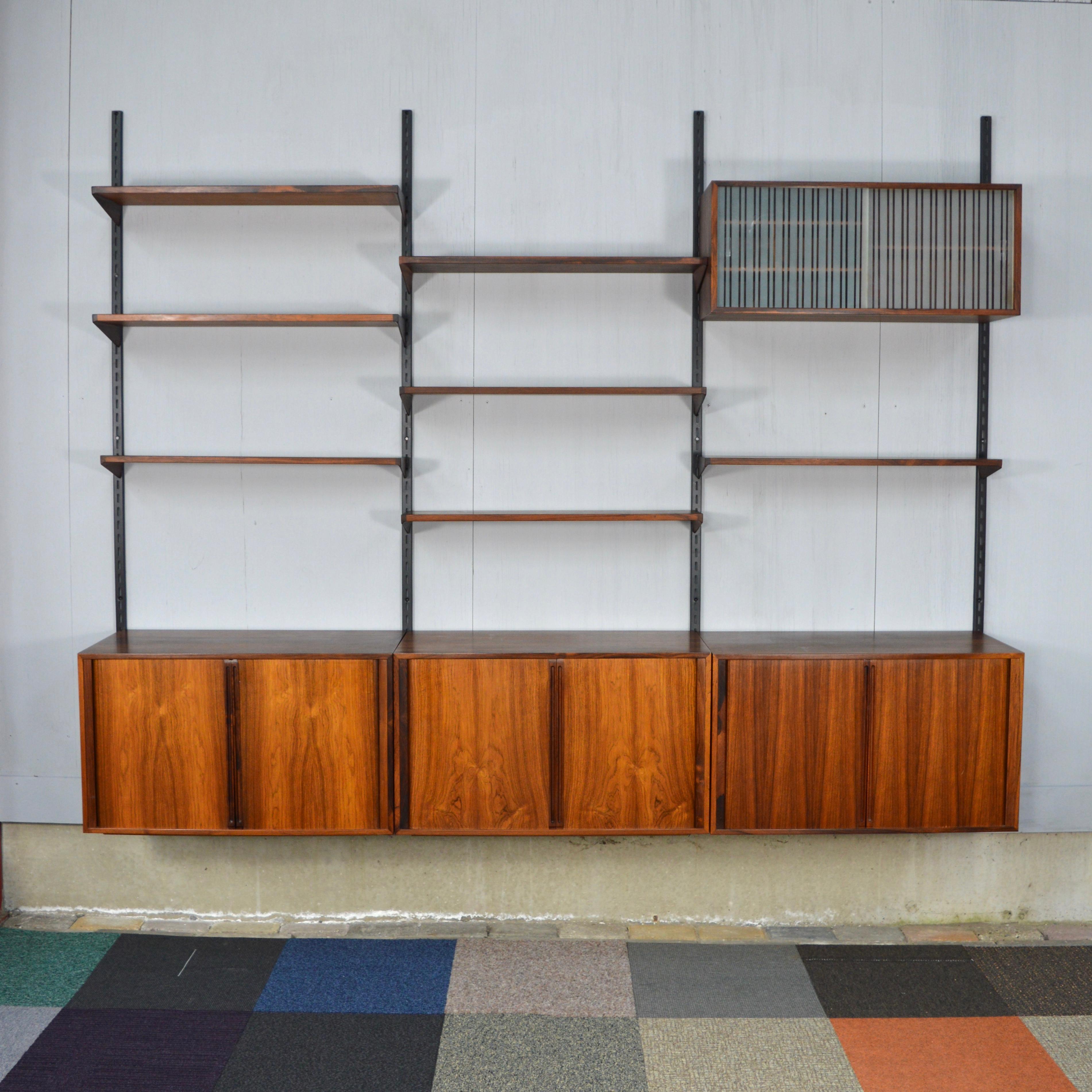 Gorgeous Brazilian rosewood wall unit by Kai Kristiansen for FM Møbler, Denmark.
The cabinets have sliding doors which are made of highly crafted lamellae that slide inside.
Inside two of the cabinets there are two birchwood drawers lined with