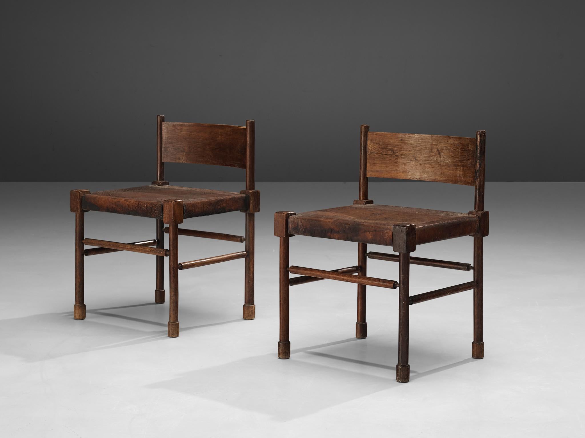 Side chairs, stained wood, patinated leather, Europe, 1940s

Rare side chairs with sculpted frame in stained wood and leather seats. What makes this design so unique is the way the designer played with proportions and shapes. The detailed carved