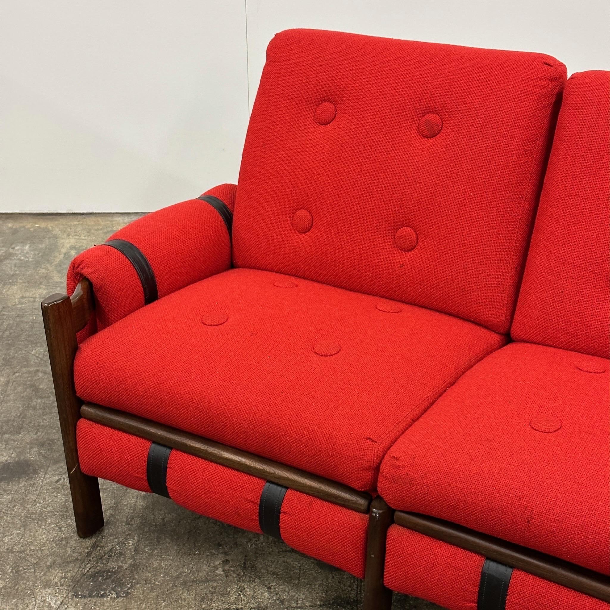 c. 1970s. Upholstered in red wool. Leather slings on arms are adjustable. Wood frame. 