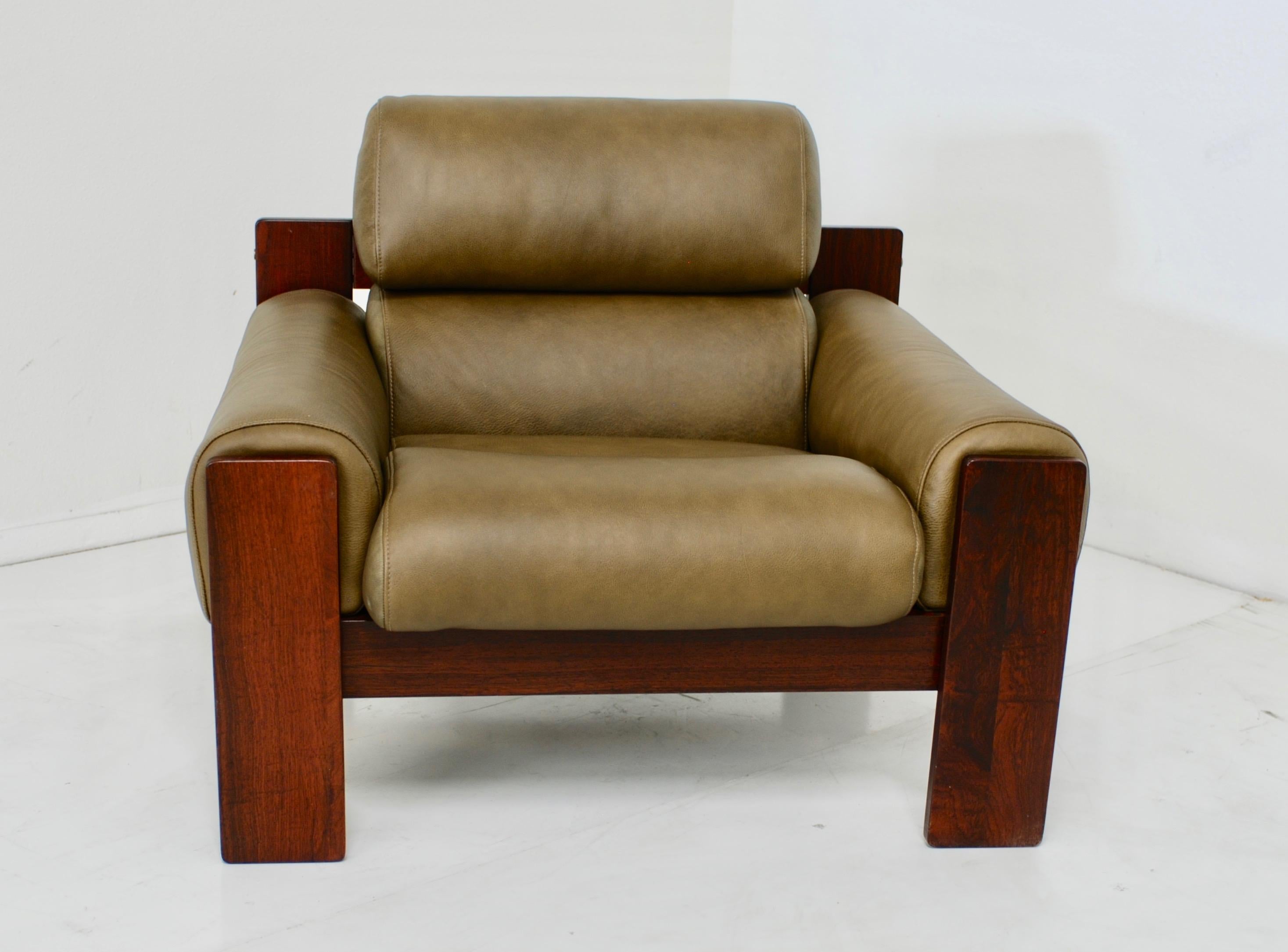 A very handsome restored vintage lounge chair in rosewood and olive green leather. The leather is a soft sage green olive color and the upholstery is extremely comfortable.