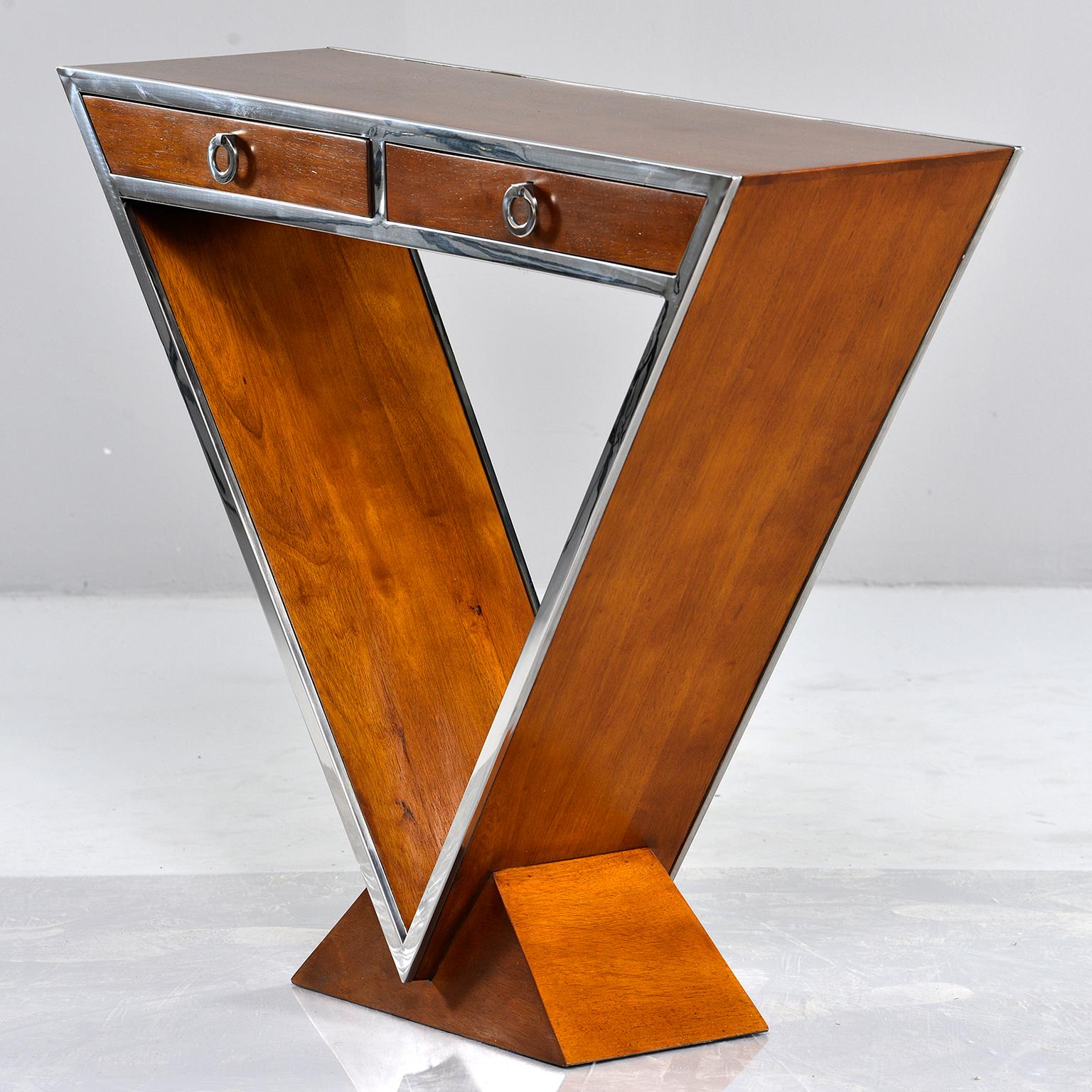 Midcentury console made of teak with chrome trim, circa 1980s. Two functional drawers, unique open triangular supports with teak pedestal base. Unknown maker. 