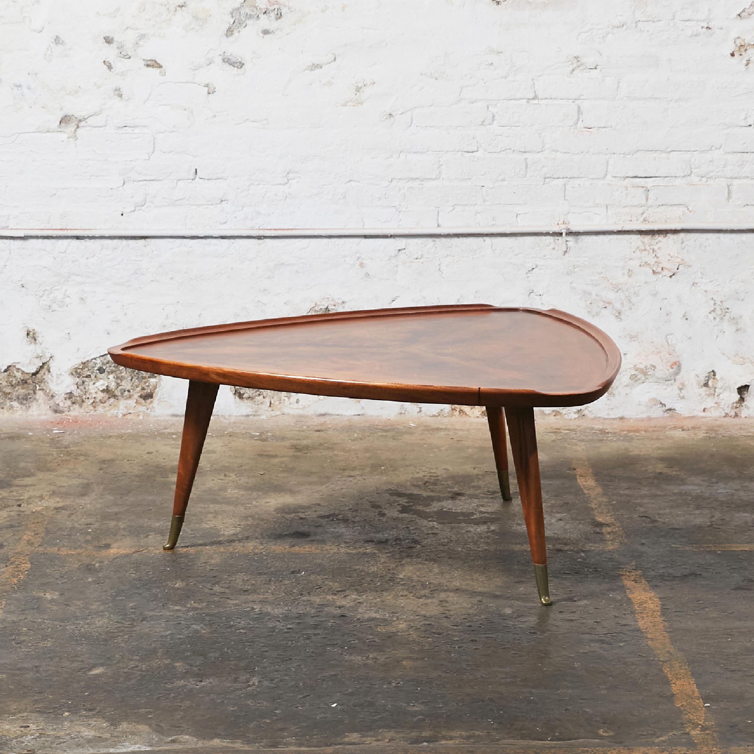 Triangular rosewood coffee table in the style of Giuseppe Scapinelli. Interrupted dovetail edge on three sides. Angled tapered legs with bronze feet. Made in Brazil, circa 1960.