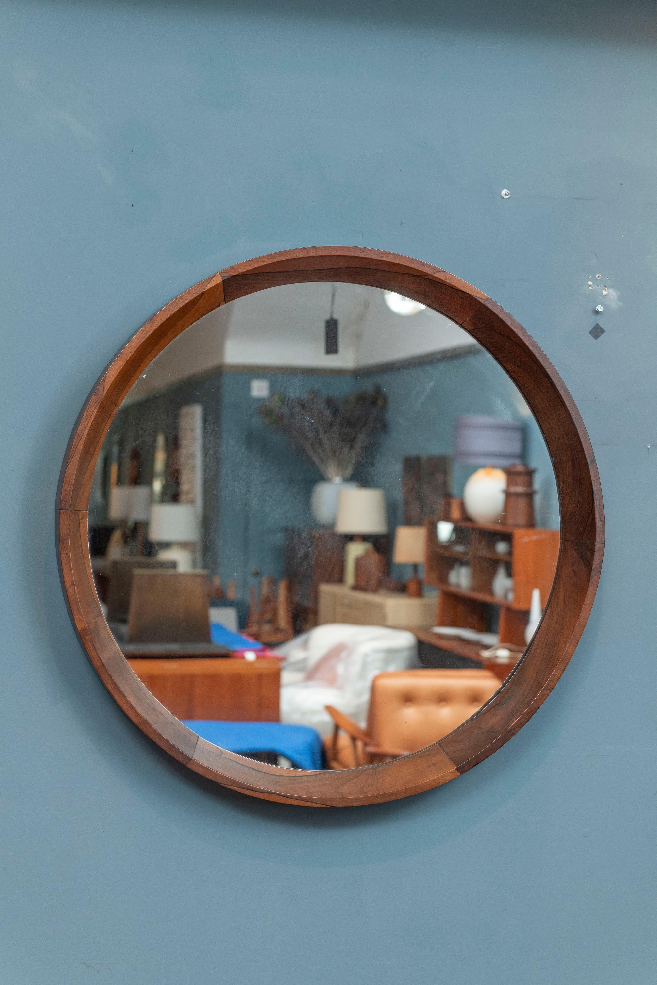 Sergio Rodrigues design circular wall mirror with a mitered interior frame in gorgeous Jacaranda wood. Large wall mirror in size and visual impact at 31.5 inches in diameter and 2.75 inches in depth. Hand made in his typical construction technique