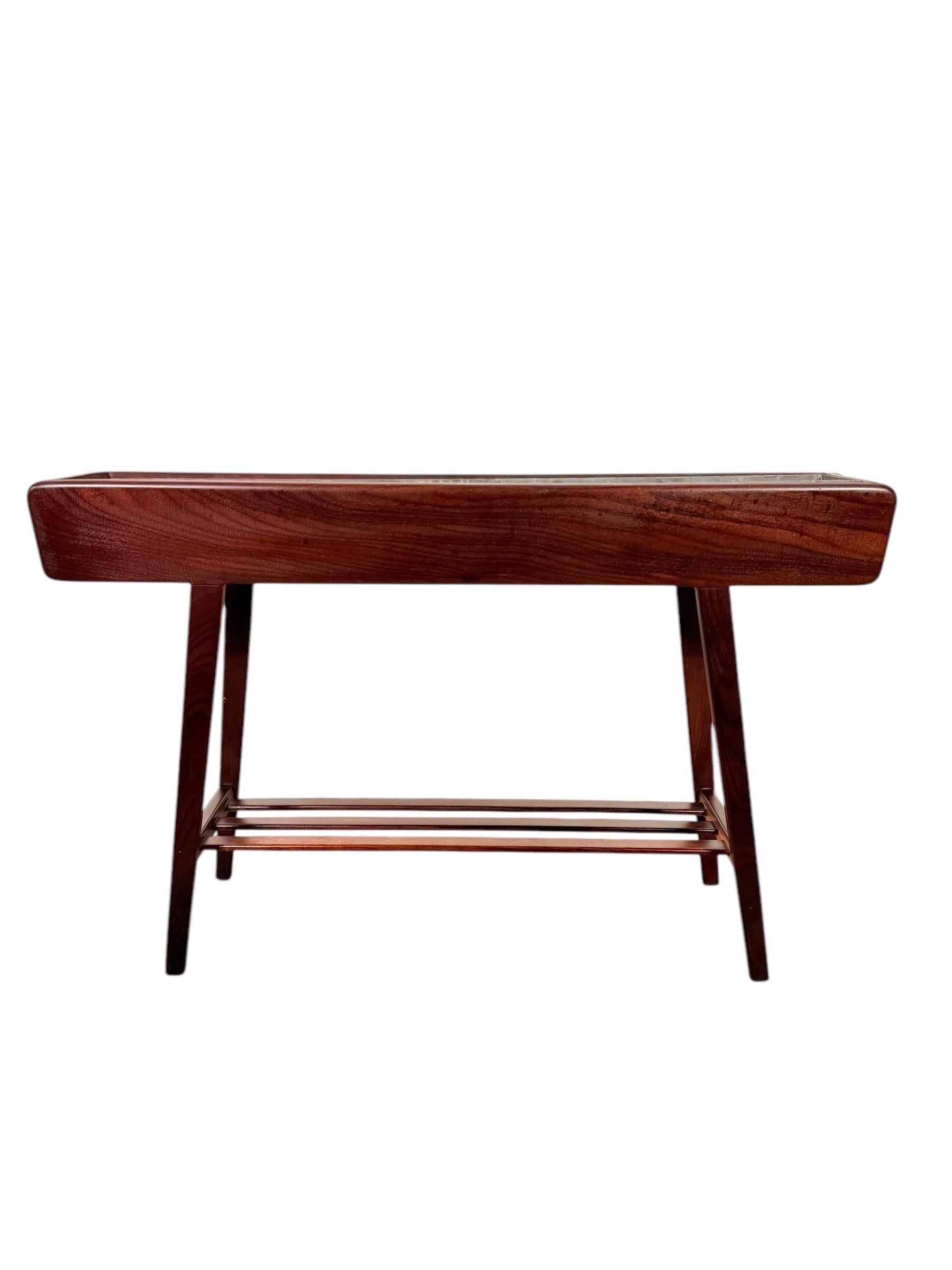 This exquisite mid-century modern planter, designed by Brdr. Dalsgaard for the prestigious Illum Bolighus in Denmark during the 1950s, embodies timeless Scandinavian design. Crafted with elegance and precision, the planter features a beautifully