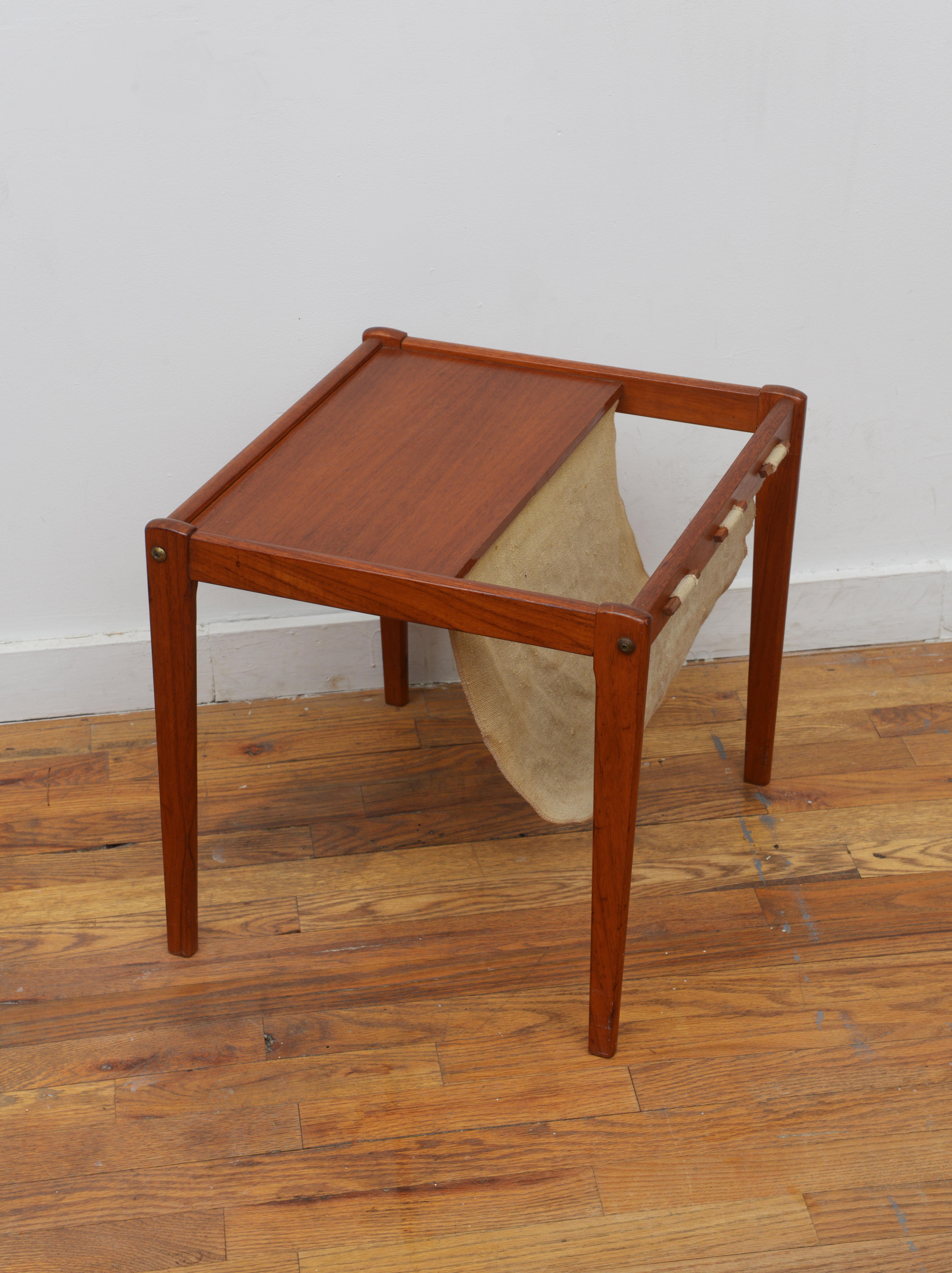 Beautiful teak Danish Modern Brdr Furbo teak end table with fabric sling magazine rack 1970s (Signed). This  vintage table is the perfect way to store your magazine collection while being a great accent to any room!