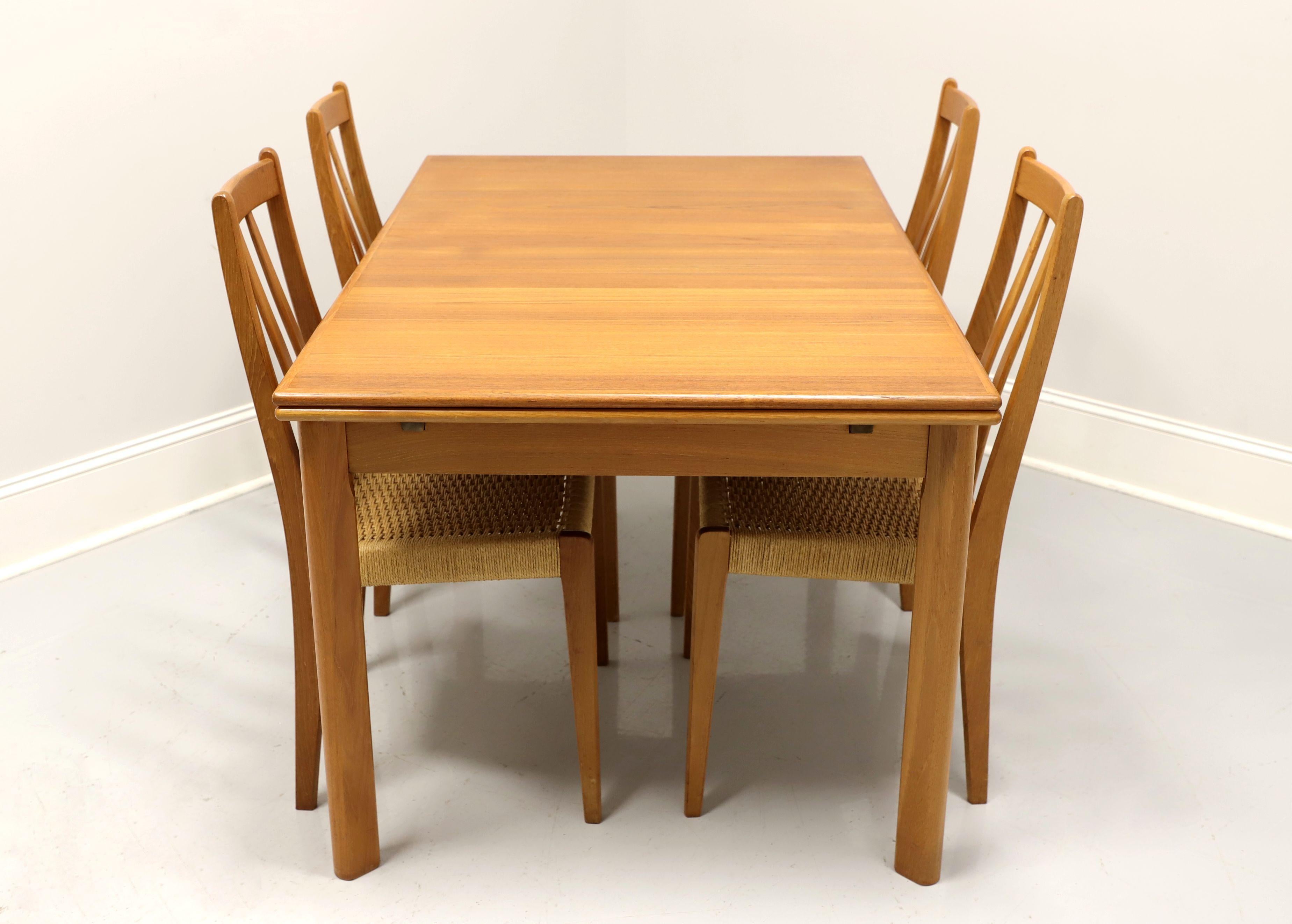 A Mid 20th Century Danish Modern dining set by BRDR FURBO. Solid teak table and chair frames with rush seats. Dining table has a banded top, two drawtop leaves that pull out from either end of the table by lifting the top, and rounded straight legs.