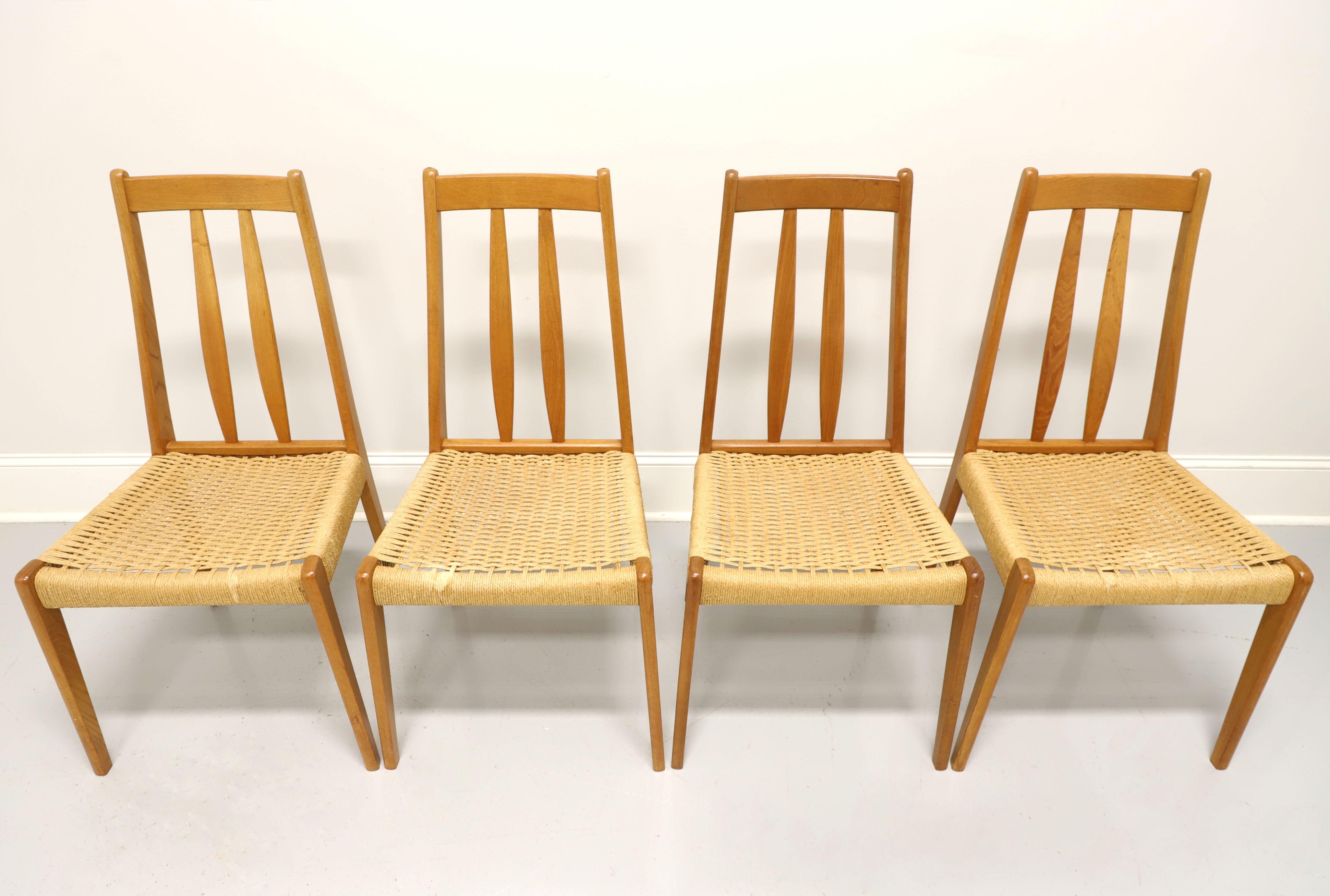 A set of four Mid 20th Century Danish Modern dining side chairs by BRDR FURBO. Solid teak with slat back, rush seat and rounded tapered legs. Made in Spottrup, Denmark, in the mid 20th Century.

Measures: Overall: 18w 20d 36.5h, Seat: 17.75w