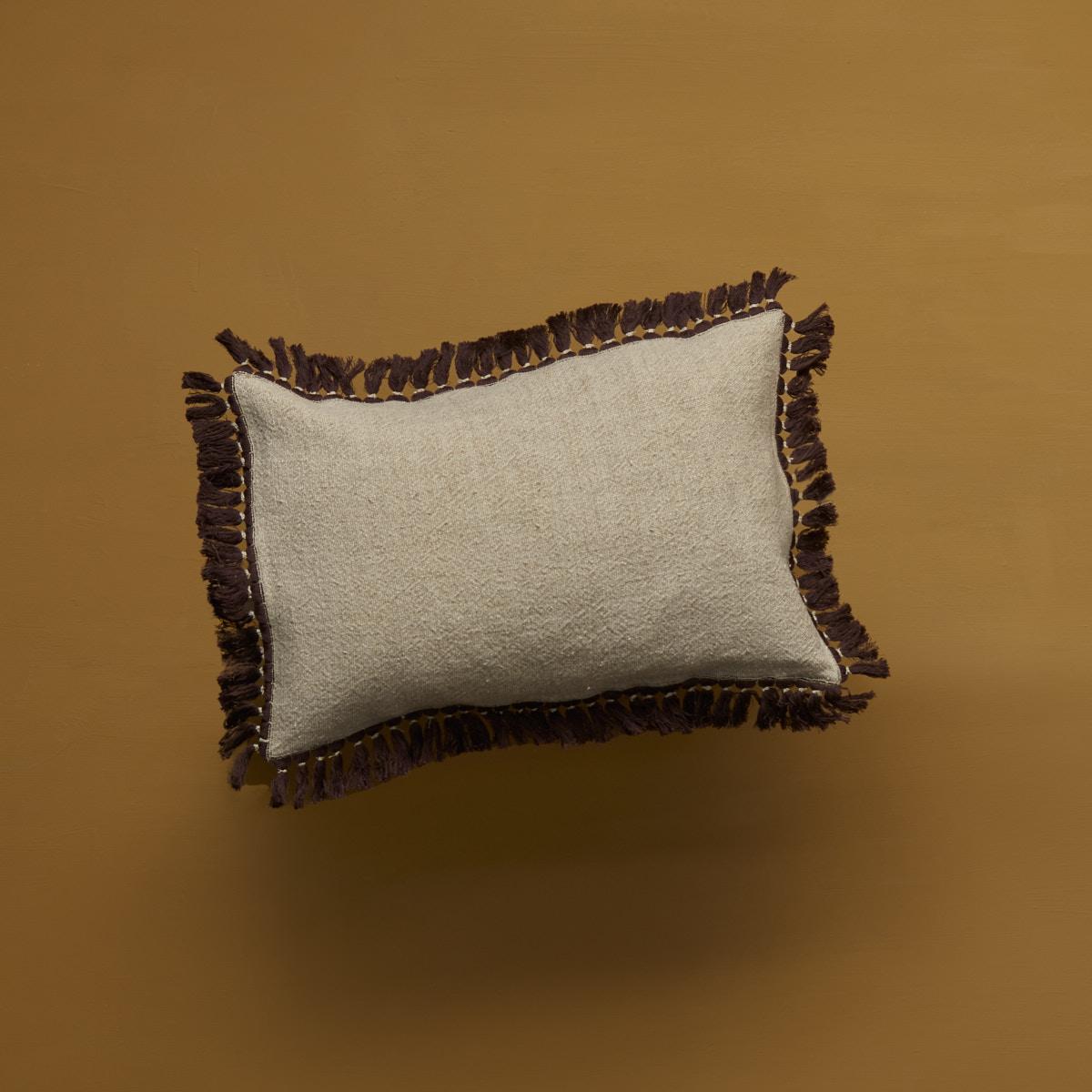Classic but not ordinary, add a new vibe to your couch with this beige and brown cushion. The linen fabric is finished with intricate grass fringe ending entirely made by hand. Comes without filler, duck feather fillers can be ordered seperately.