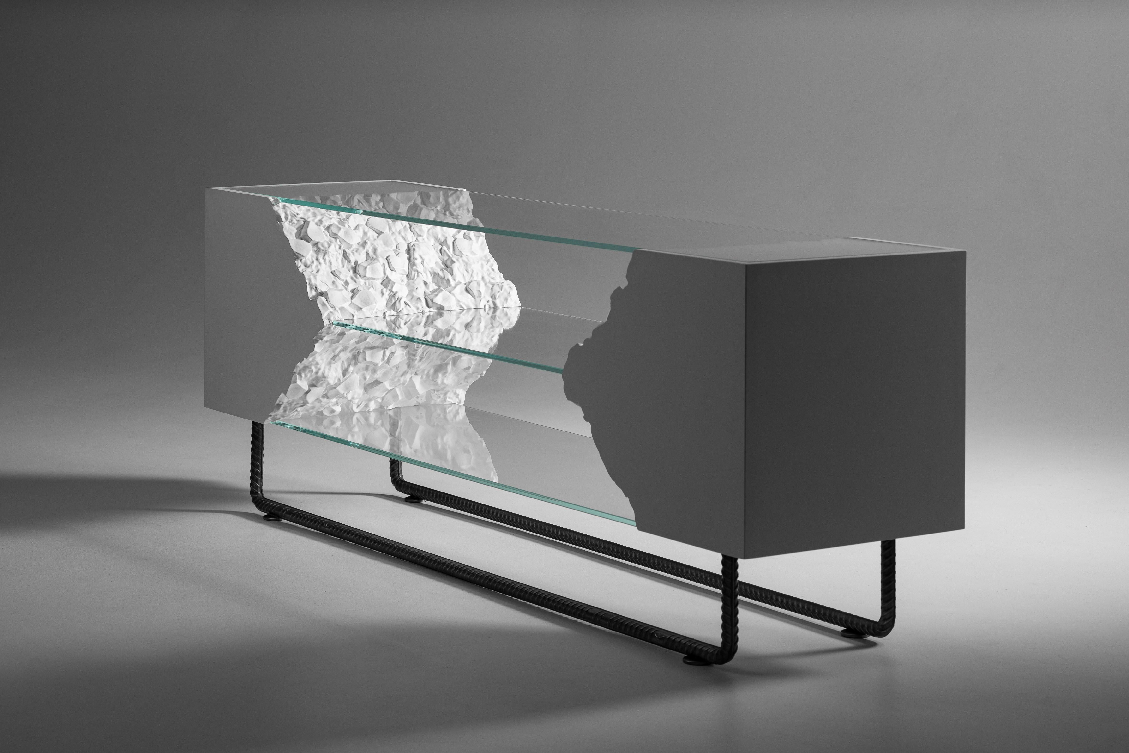 Break Free Console Table by PANOPTIKUM COLLECTIONS
Dimensions: D 45 x W 180 x H 65 cm.
Materials: Solid wood, plywood, glass, veneer, and soft-touch painting.

When looking at the console, it seems that the brute power of the stone hides within it.
