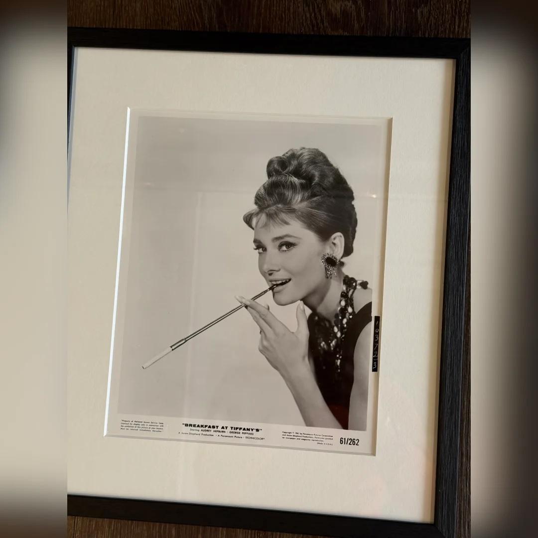 Breakfast at Tiffany's (1961) - FRAMED
Photo Still (8 X 10 Inches)

Original Paramount Pictures photographic production still #10372/3.

This timeless original studio still captures Audrey Hepburn in her most iconic role as Holly Golightly—elegant,