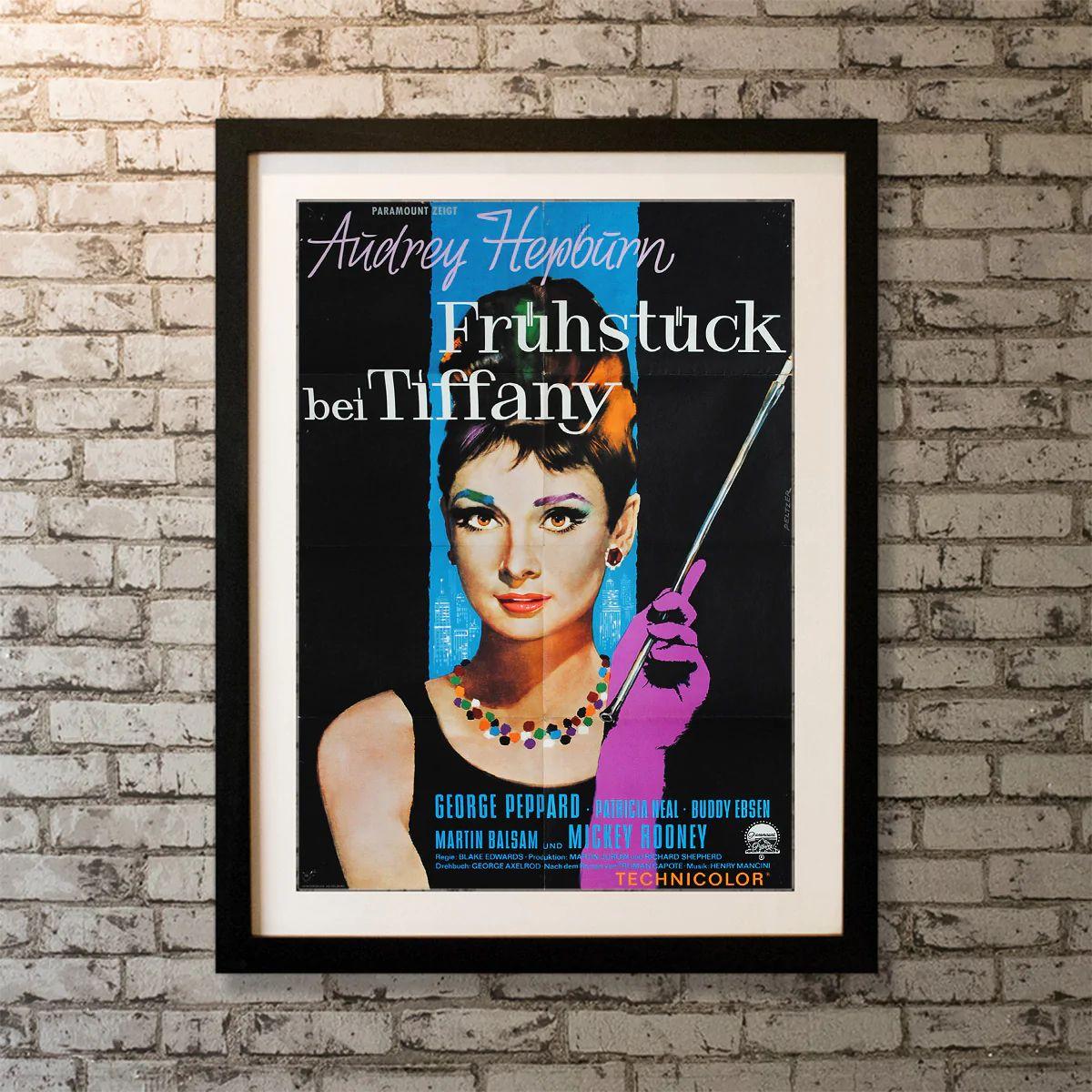 Breakfast At Tiffany's, Unframed Poster, 1961

Original German Poster (23 X 33 Inches). Holly Golightly's image is one of the most famous in movie history. It's all on display in this German poster -- the black dress, cigarette holder and gloves.
