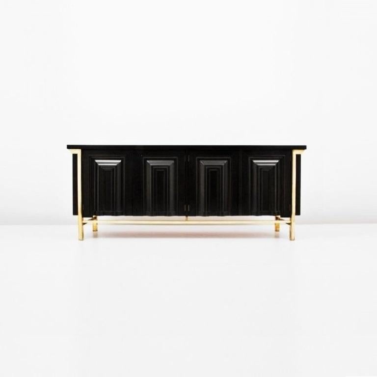 This stunning and distinct black lacquered and brass detail credenza or sideboard by Mastercraft. Meticulous attention to detail and superb construction, with graphic geometric door design and architecturally inspired platform base. Top features