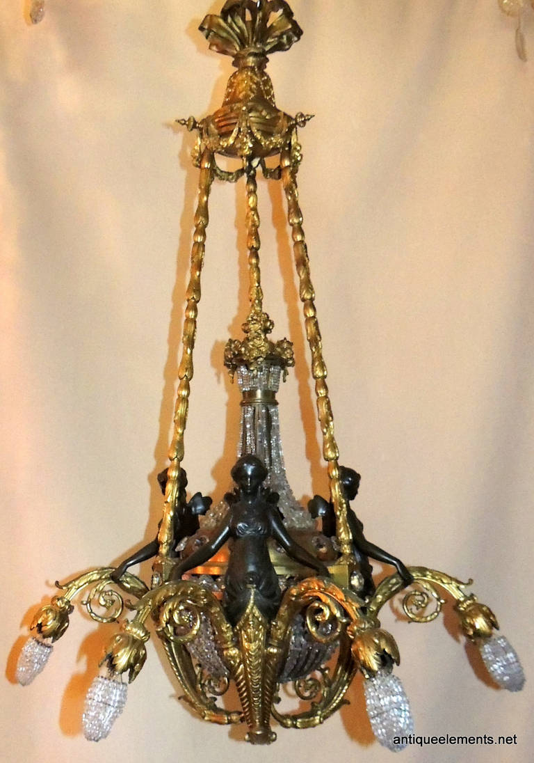 This beautifully detailed bronze chandelier is decorated with four, 8