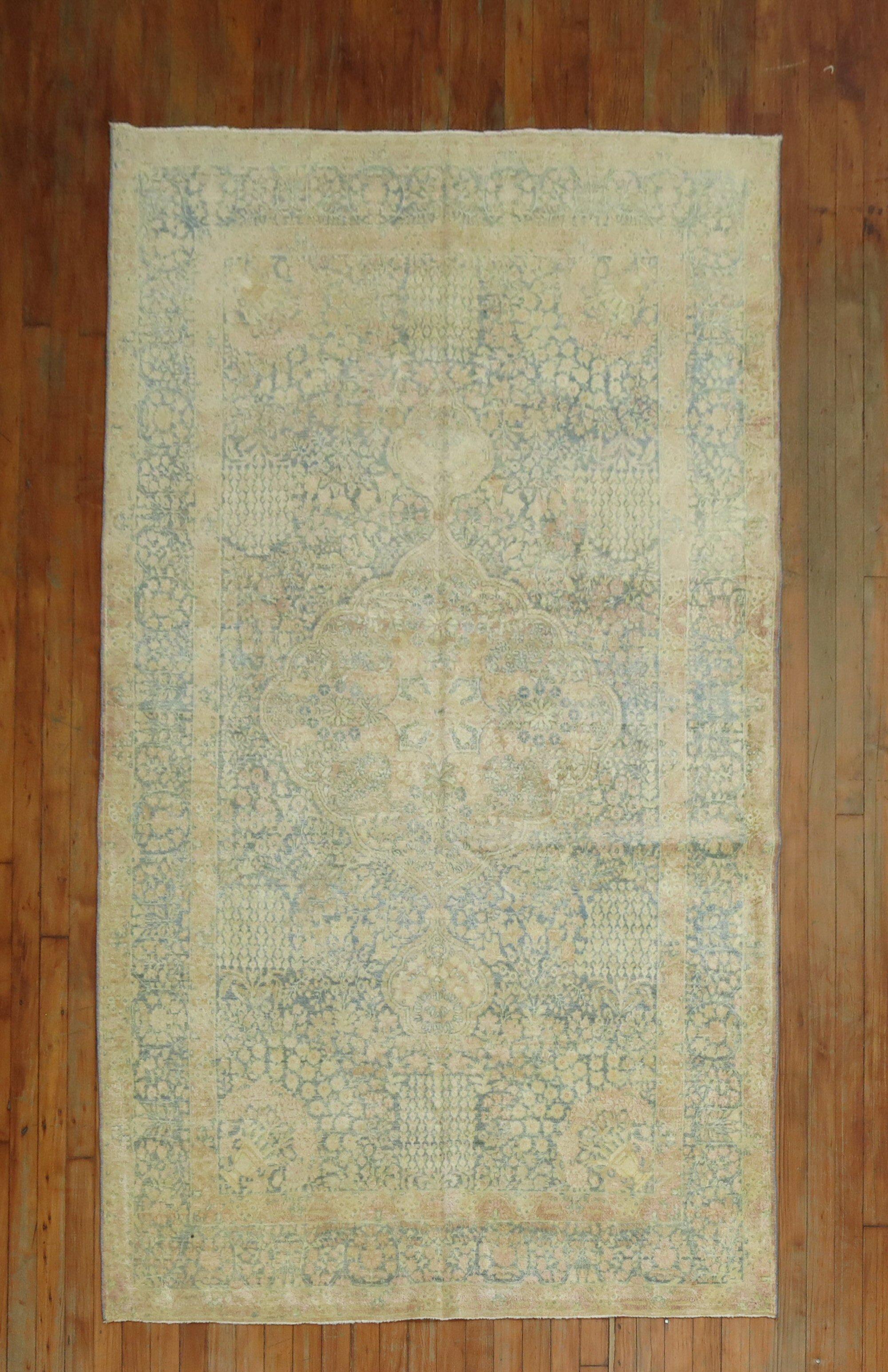 An early 20th century formal Persian Kerman Rug in pastel tones.

Measures: 4'6'' x 7'10''