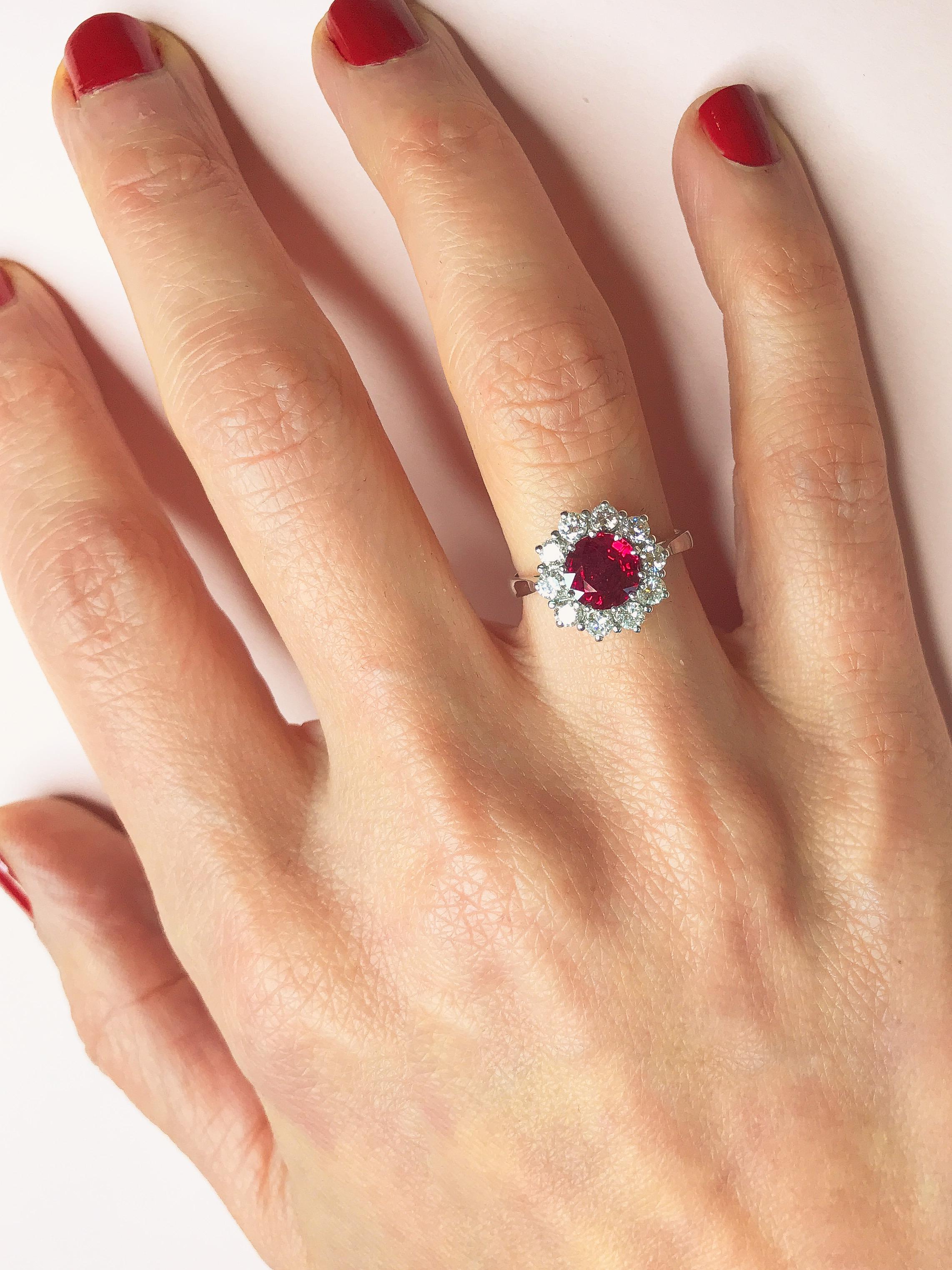 A deep red ruby hand-picked from the Haruni vault makes a striking centrepiece for this spectacular white gold ring. The round cut stone boasts a rich, vivid colour, further amplified by its surround of sparkling white diamonds. This is an