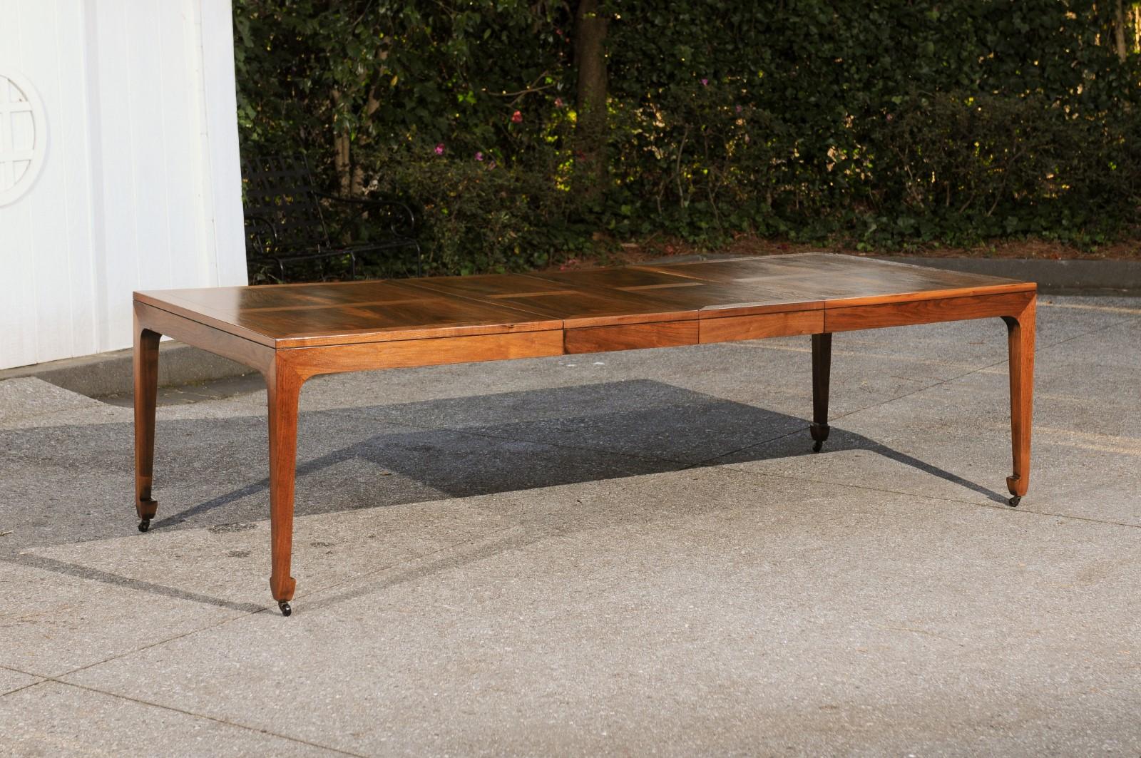 This magnificent dining table is shipped as professionally photographed and described in the listing narrative: Meticulously professionally restored and installation ready. 

A fabulous vintage extension dining table in solid walnut by Baker