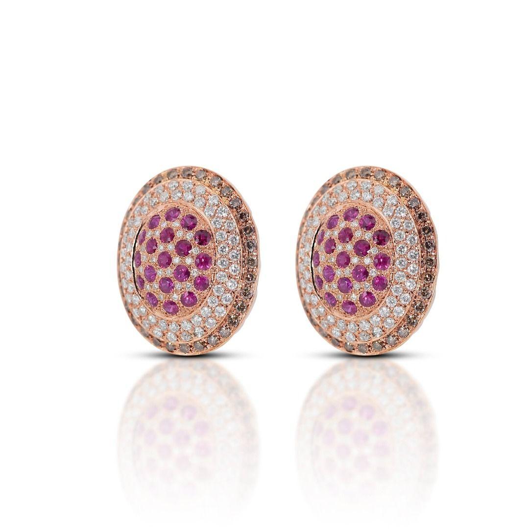 These earrings are a breathtaking cascade of vibrant red and icy brilliance, featuring a captivating ensemble of rubies and diamonds set in gleaming 18K two-tone gold. 36 round brilliant rubies, totaling a mesmerizing 1.36 carats, take center stage