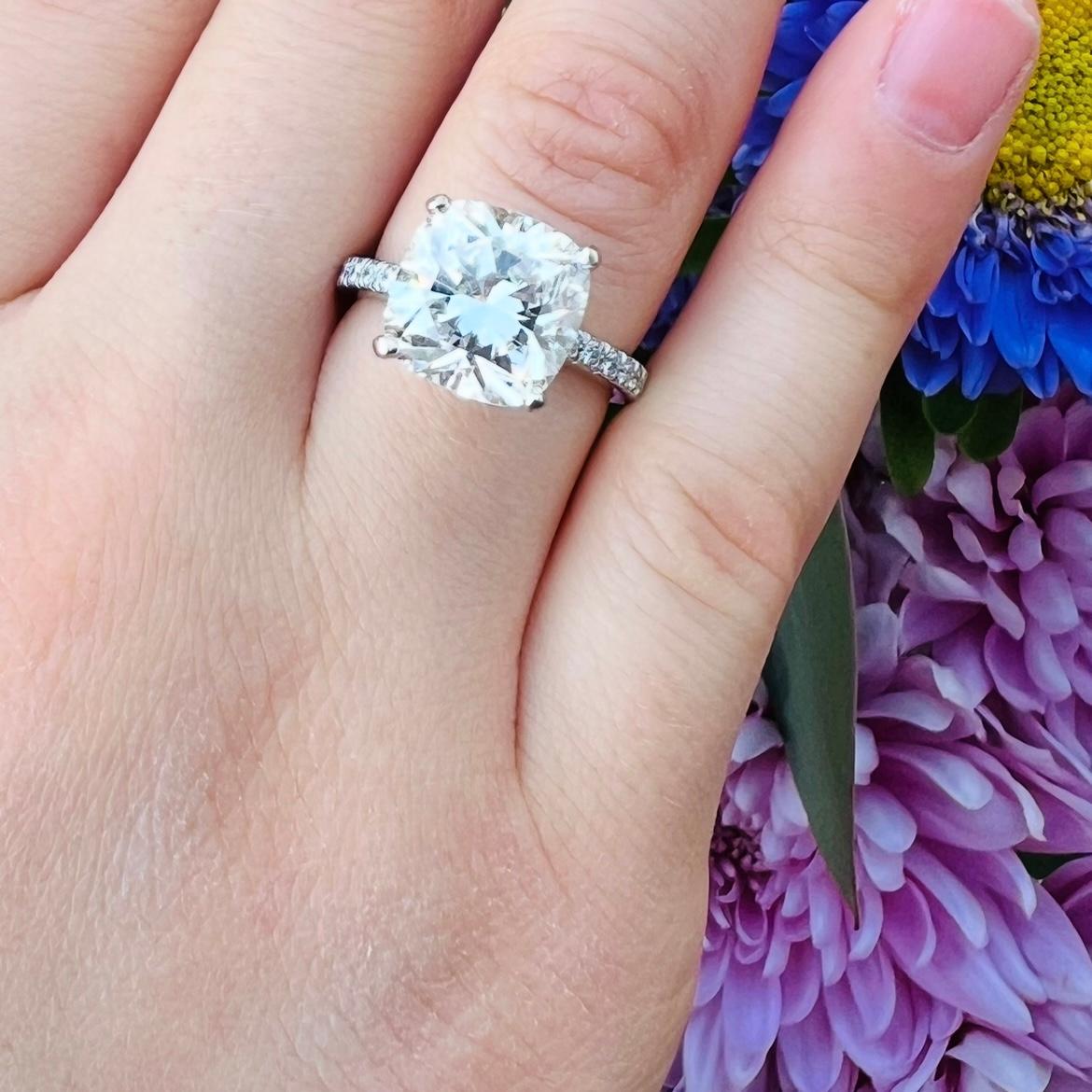There's extraordinary, and then there's THIS! An extraordinary ring from the one and only Tiffany & Co features at its center an exceptional 4.05 carat Cushion Cut Diamond expertly set with four prongs in a platinum mounting that is accentuated by