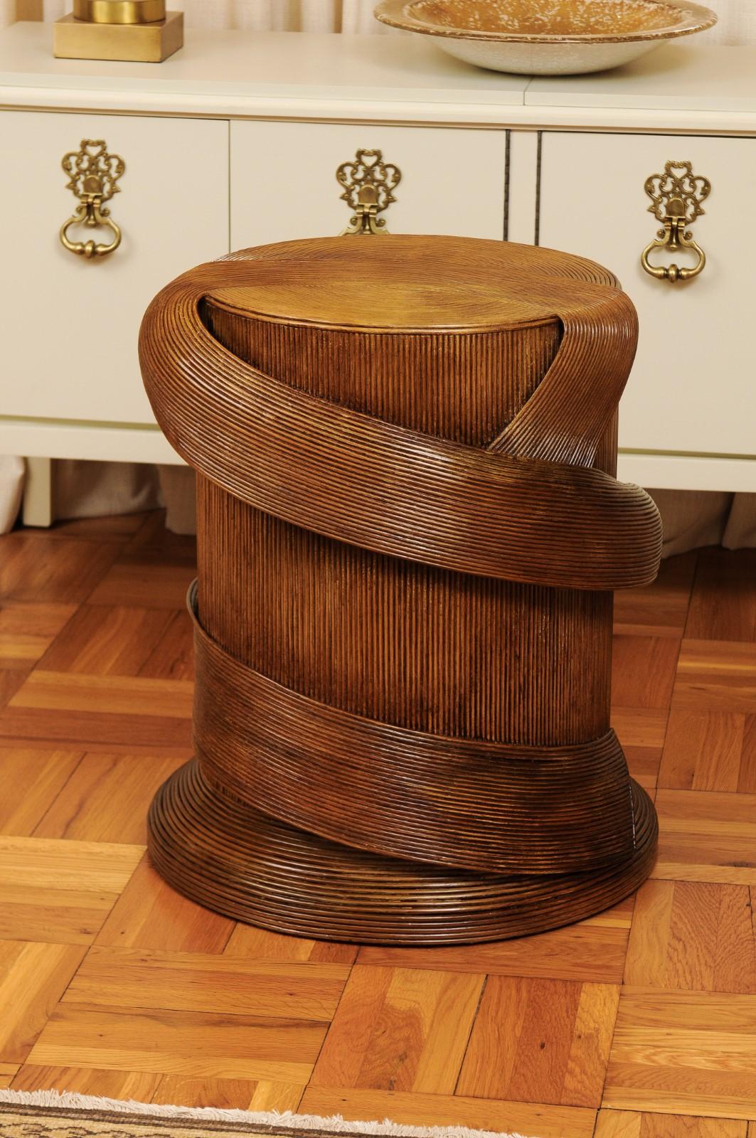 A remarkable Tromp L'oiel style dining or center table by the visionary Betty Cobonpue, circa 1980. Steamed reed rattan with a stunning ribbon detail over solid mahogany construction. Rich tobacco color mellowed to perfection. A magnificent Art