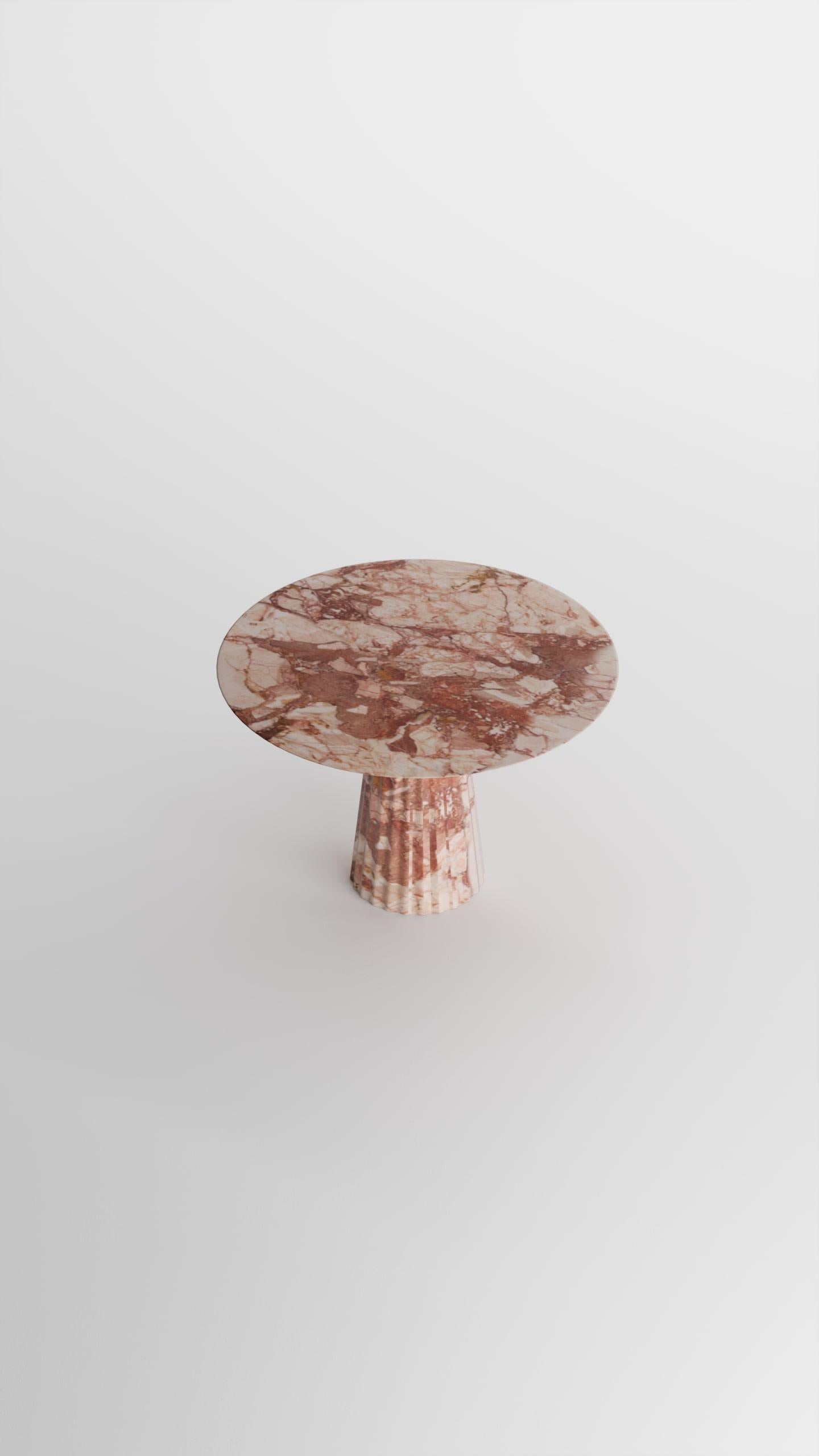 Introducing our exquisite dining table crafted from Breccia Pernice marble, designed to elevate your dining area with unparalleled elegance. The round top and tapered pedestal base of this table beautifully showcase rich, earthy tones and intricate